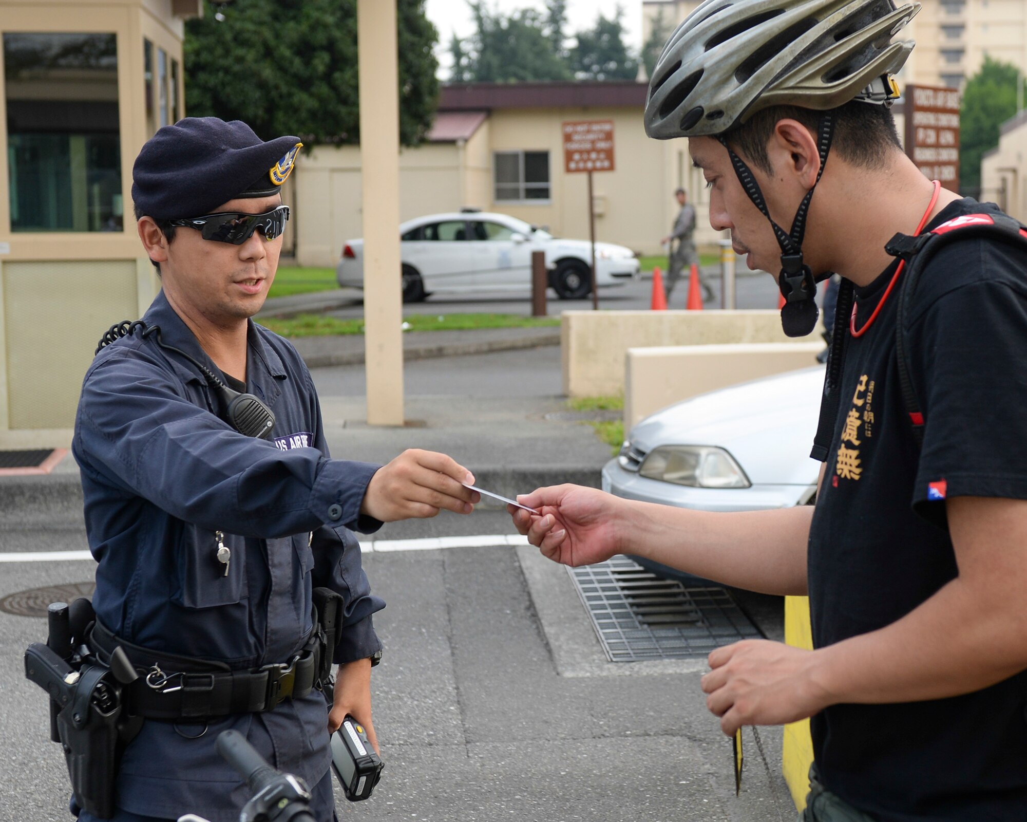 Masafumi Shinozuka, civilian guard, clears a visitor’s controlled access card at Yokota Air Base, Japan, July 29, 2015. Many civilian guards have been securing Yokota’s gates for more than 20 years, allowing Airlifters to continue the mission without unauthorized visitors entering base. (U.S. Air Force photo by Airman 1st Class Elizabeth Baker/Released)