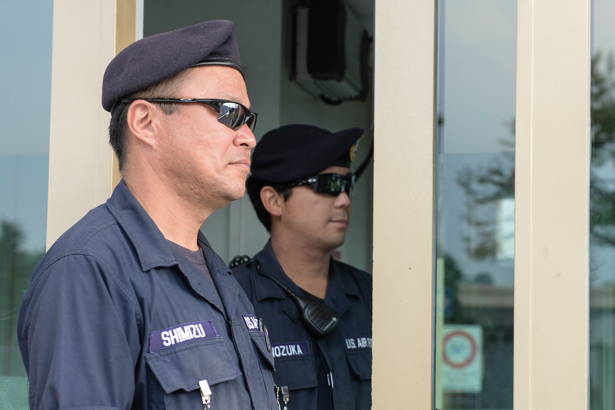 Wataru Shimizu and Masafumi Shinozuka, civilian guardsmen, work together to secure Fussa gate at Yokota Air Base, Japan, July 29, 2015. Security forces Airmen describe Yokota’s civilian guards as hard-working, knowledgeable and effective. (U.S. Air Force photo by Airman 1st Class Elizabeth Baker/Released)