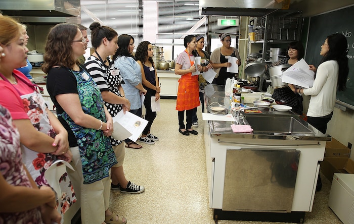 Mikie Watanabe, cultural adaption specialist, right, and Sachiko Tamura, left, a member of Eating Habits Improvement Promotion, begin a Japanese Cooking Class at Fukushi Kaikan in Iwakuni City, Japan, July 24, 2015. Coordinated by the Cultural Adaption Program aboard Marine Corps Air Station Iwakuni, the class is held three times a year and is one of many ways to indulge in local cuisine. In this specific class, guests learned how to make handmade Shumai, Wakame soup and traditional fried rice. 