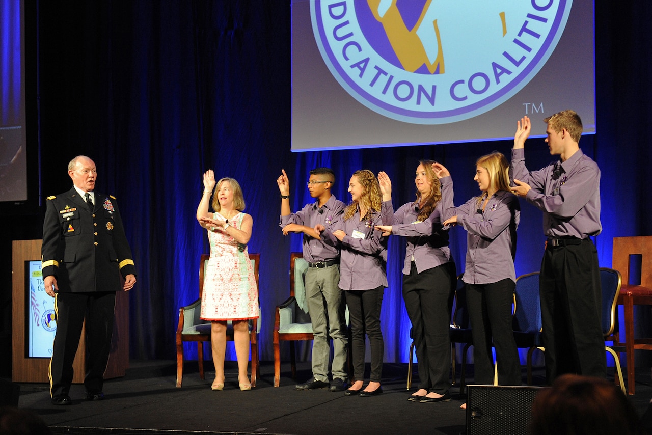 Army Gen. Martin E. Dempsey, chairman of the Joint Chiefs of Staff, and his wife, Deanie, sing a traditional Irish folk song with military children at the start of the Military Child Education Coalition 17th National Training Seminar in Washington, D.C., July 30, 2015. DoD photo by Marvin Lynchard