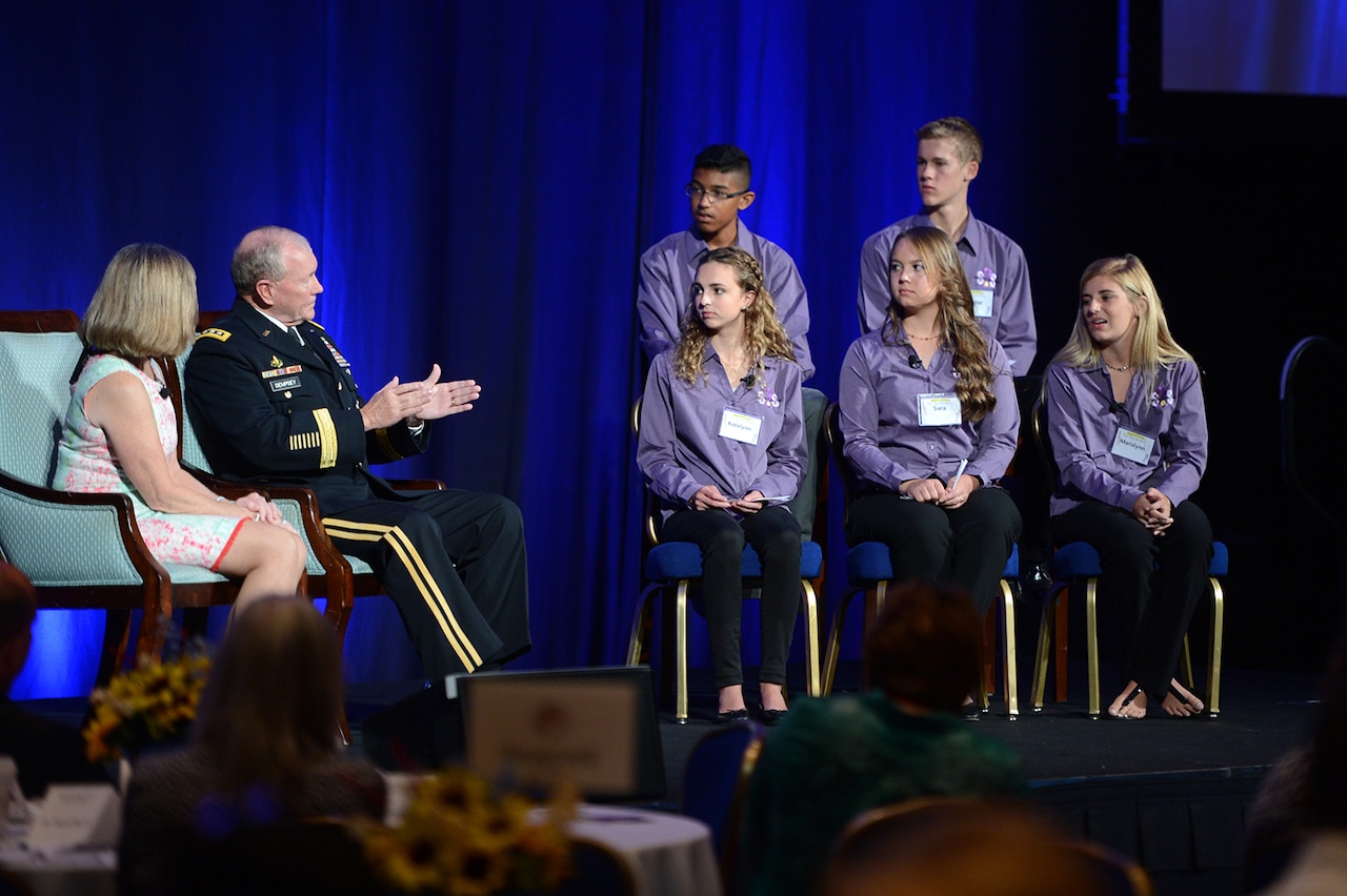 Army Gen. Martin E. Dempsey, chairman of the Joint Chiefs of Staff, and his wife, Deanie, take questions from Student 2 Student members, top row from left, Raul Rosales IV, 15, from San Antonio, Texas; Hunter Hughes, 15, from Falcon, Colo.; bottom row from left, Katelyn Jensen, 16, from Falcon, Colo., Sara Lippert, 17, from Dupont, Wash.; and Marislynn Turnmeyer, 17, from Panama City, Fla., during the opening general session of The Military Child Education Coalition 17th National Training Seminar, July 30, 2015, at the Washington Marriott Wardman Park hotel in Washington, D.C. DoD photo by Marvin Lynchard