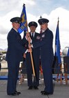 Col. Randy Huiss, 15th Wing commander, takes the  guidon from Col. David Pastore, former 15th Maintenance Group commander, during the change of command ceremony on Joint Base Pearl Harbor-Hickam, Hawaii, July 28, 2015. Pastore assumed command of the 15th MXG in July of 2013 and was presented the Legion of Merit for his outstanding service and accomplishments during the ceremony. (U.S. Air Force Photo by Tech Sgt. Aaron Oelrich/Released)