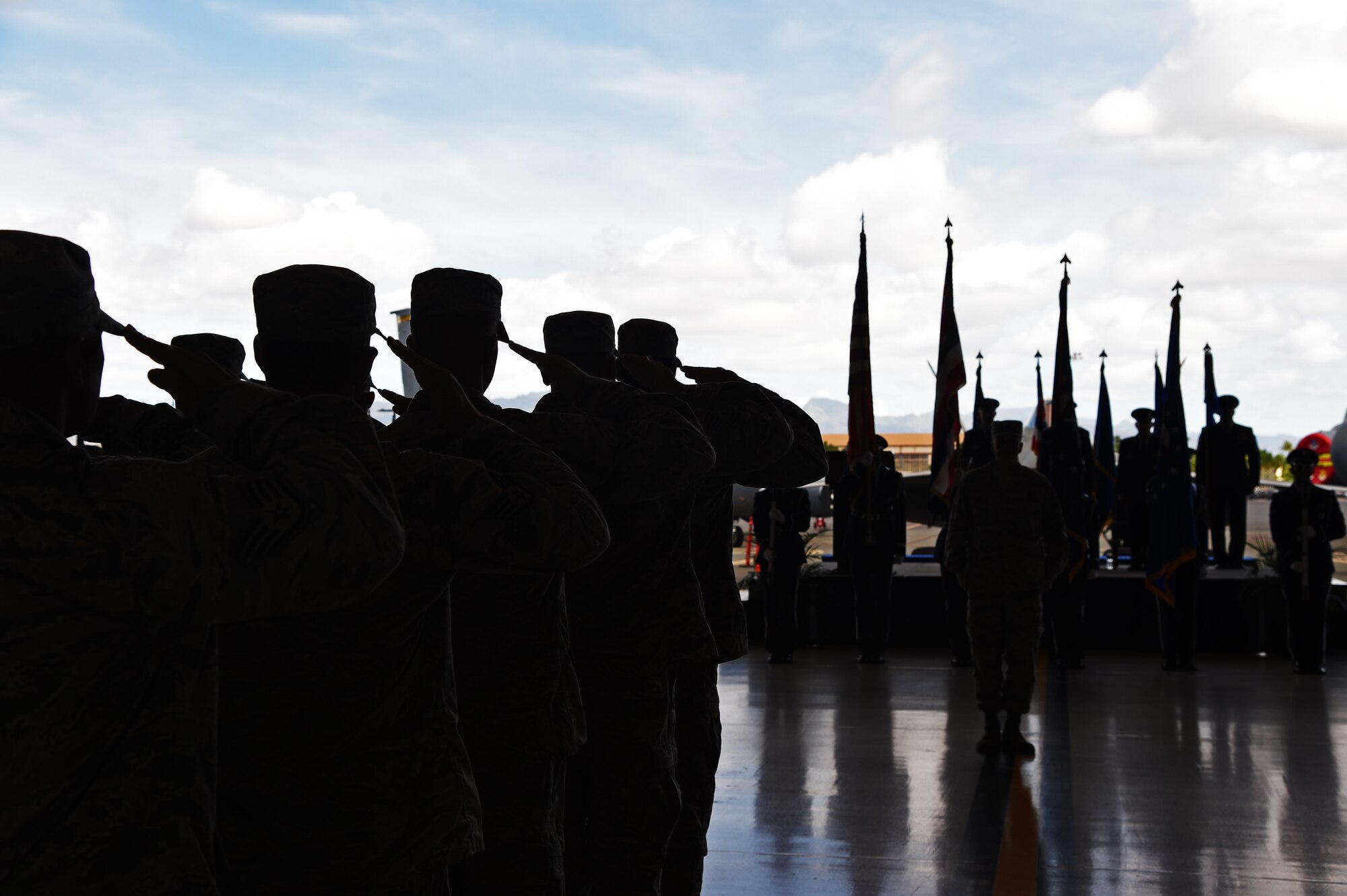 Airmen from the 15th Maintenance Group salute the U.S. Flag during the national anthem as a part of the 15th MXG change of command ceremony on Joint Base Pearl Harbor-Hickam, Hawaii, July 28, 2015. Col. Robert Copes assumed command of the 15th MXG from Col. David Pastore. (U.S. Air Force photo by Tech. Sgt. Aaron Oelrich/Released)