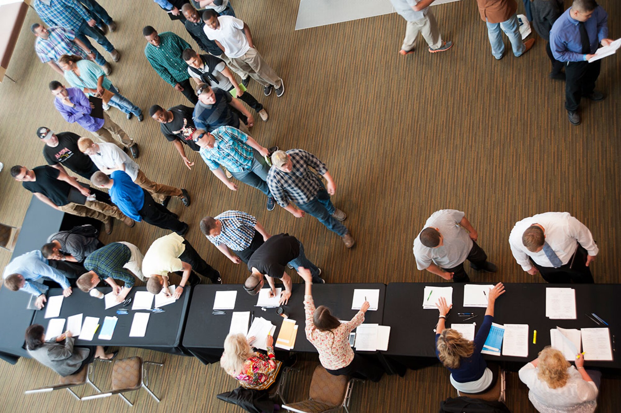 Service members, veterans and their spouses register for the first Joint Base Elmendorf-Richardson Transition Summit at the Dena’ina Center in downtown Anchorage, Alaska, July 22, 2015. The summit provided participants with workshops to help them learn the skills to be competitive job seekers. (U.S. Air Force photo/Senior Airman Tammie Ramsouer)