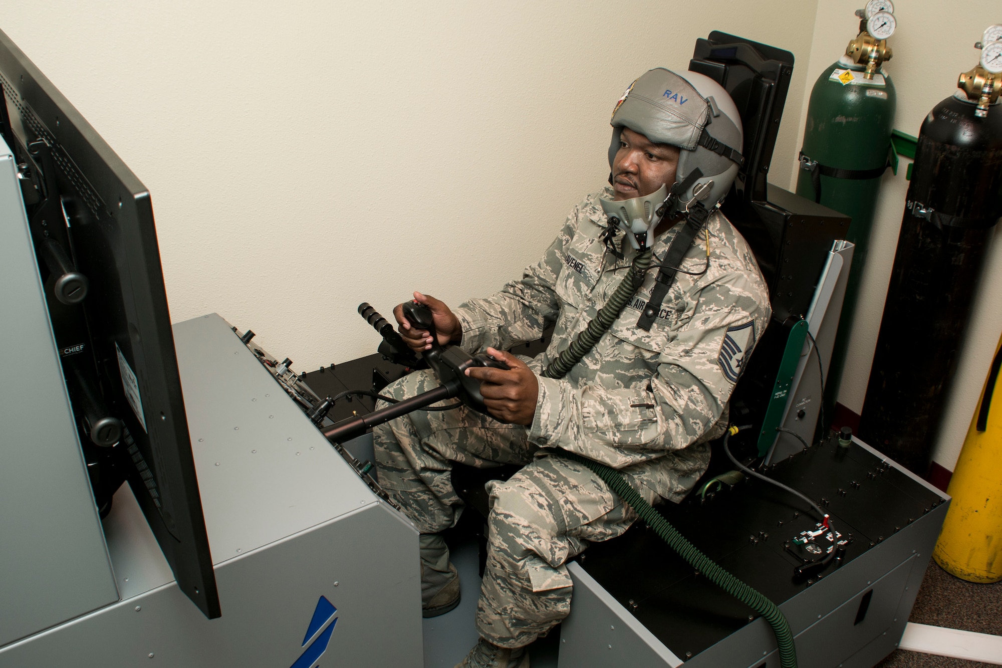 Master Sgt. Keith Ravenel, 60th Medical Operations Squadron aerospace physiology technician, demonstrates how aircrew members utilize the Reduced Oxygen Breathing Device/Hypoxia Familiarization Trainer, July 8, 2015, as part of mandatory refresher physiology training at Travis Air Force Base, California. The ROBD is a small device that mixes compressed gases to simulate altitude exposure and the HFT is an aircraft simulator that can be configured to mimic any aircraft. (U.S. Air Force photo by Senior Airman Charles Rivezzo)