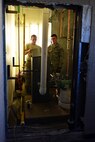 Senior Airman Julian Donahue and Airman 1st Class Joseph Konecny, 341st Civil Engineer Squadron Heating Ventilation and Air Conditioning technicians, take the top cover off of a boiler to access the main control board July 30, 2015, at Malmstrom Air Force Base, Mont. HVAC completed 102 job orders for the month of July. (U.S. Air Force photo/Chris Willis)