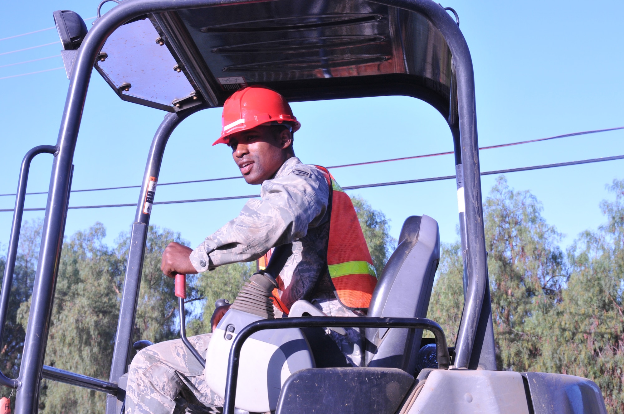 An Airman with the 567th Rapid Engineer Deployable Heavy Operational Repair Squadron Engineers from Seymour Johnson Air Force Base, North Carolina, assists the Santa Rosa Band of Cahuilla Indian community in Mountain Center, Calif., with reconstruction of a dam in June. (U.S. Air Force photo/Tech. Sgt. Terrica Jones)