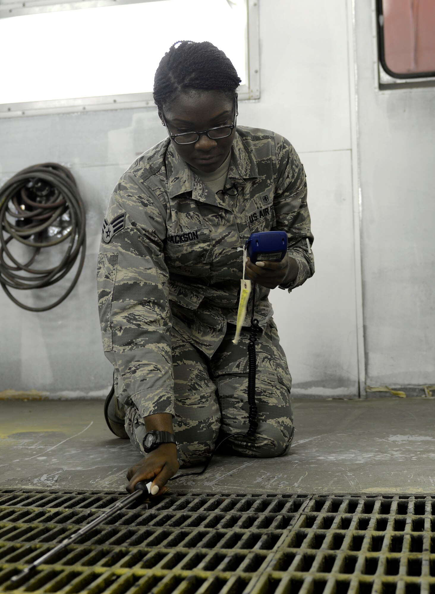 Senior Airman Shakira Jackson,  22nd Aerospace Medicine Squadron bioenvironmental technician, gets a velocity reading of a ventilation system, July 29, 2015, at McConnell Air Force Base, Kan. Readings are obtained once a quarter, depending on the chemicals used in a particular work center, to ensure the area is safe for use by Airmen. (U.S. Air Force photo by Senior Airman Trevor Rhynes)