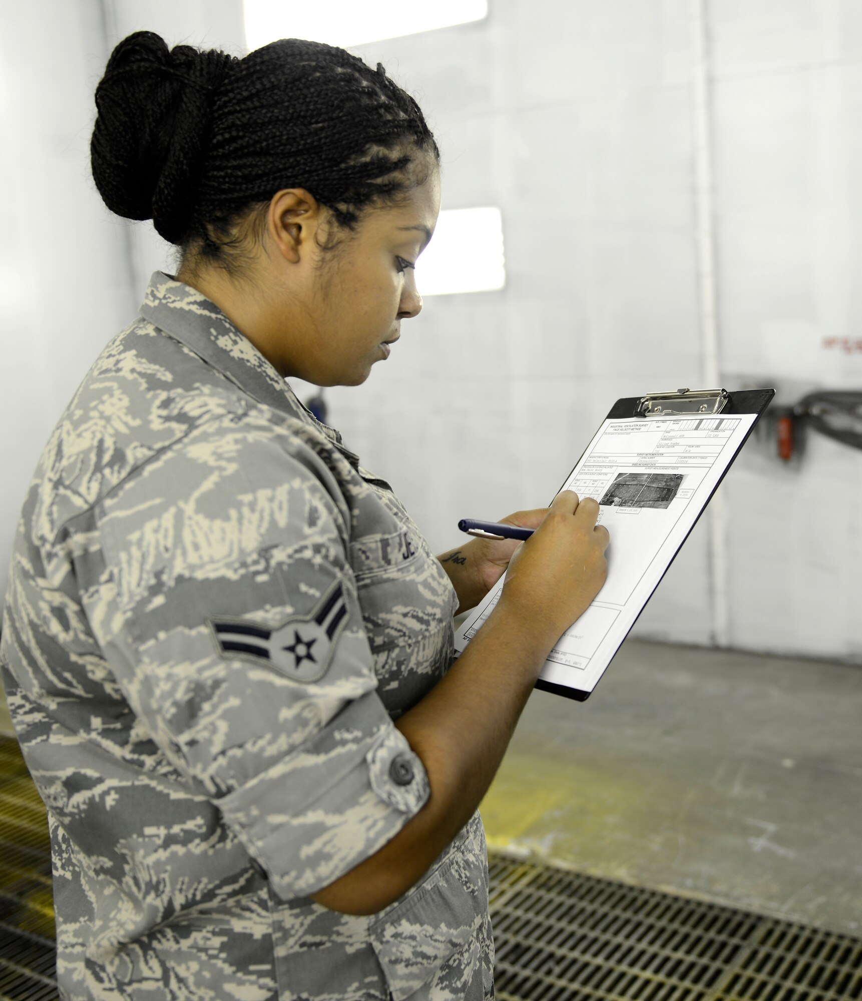 Airman 1st Class Natasha Jeter, 22nd Aerospace Medicine Squadron bioenvironmental technician, annotates a velocity reading, July 30, 2015, at McConnell Air Force Base, Kan. Airmen from the bioenvironmental shop monitor vents in industrial work centers to ensure they’re operating to Air Force standards and are safe for use by the Airmen who operate them. (U.S. Air Force photo by Senior Airman Trevor Rhynes)