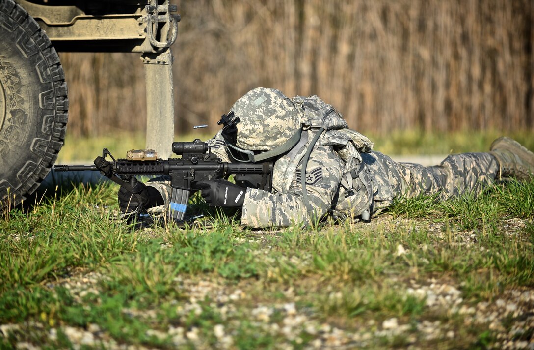 A 932nd Airlift Wing Security Forces Squadron (SFS) team member takes a prone position to return fire during a field exercise June 9, 2015 near the Sparta Shooting Complex, Sparta Ill.  Airmen with the 932nd AW SFS engaged enemy personnel at various locations.  All members wore protective gear and fired special paint rounds to simulate a live fire scenario.  The training was during annual tour for most reservists, and included perimeter sweeps, securing the wooded outpost, and a variety of patrols which led to simulated encounters with enemy forces. (U.S. Air Force photo/Tech. Sgt. Christopher Parr)

