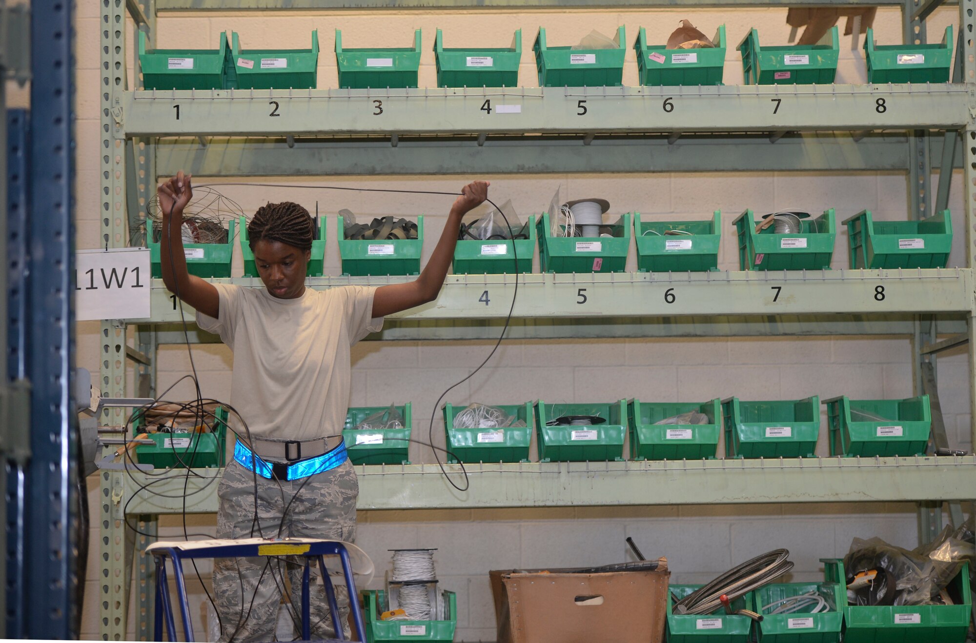 Airman 1st Class Arrielle Conver, 22nd Logistics Readiness Squadron aircraft parts store journeyman, untangles cables before measuring them, July 29, 2015, at McConnell Air Force Base, Kan. The Airmen in the aircraft parts store ensure the maintenance shops get the parts required to provide crucial maintenance for the KC-135 Stratotanker to accomplish its mission. (U.S. Air Force photo by Senior Airman Colby Hardin)