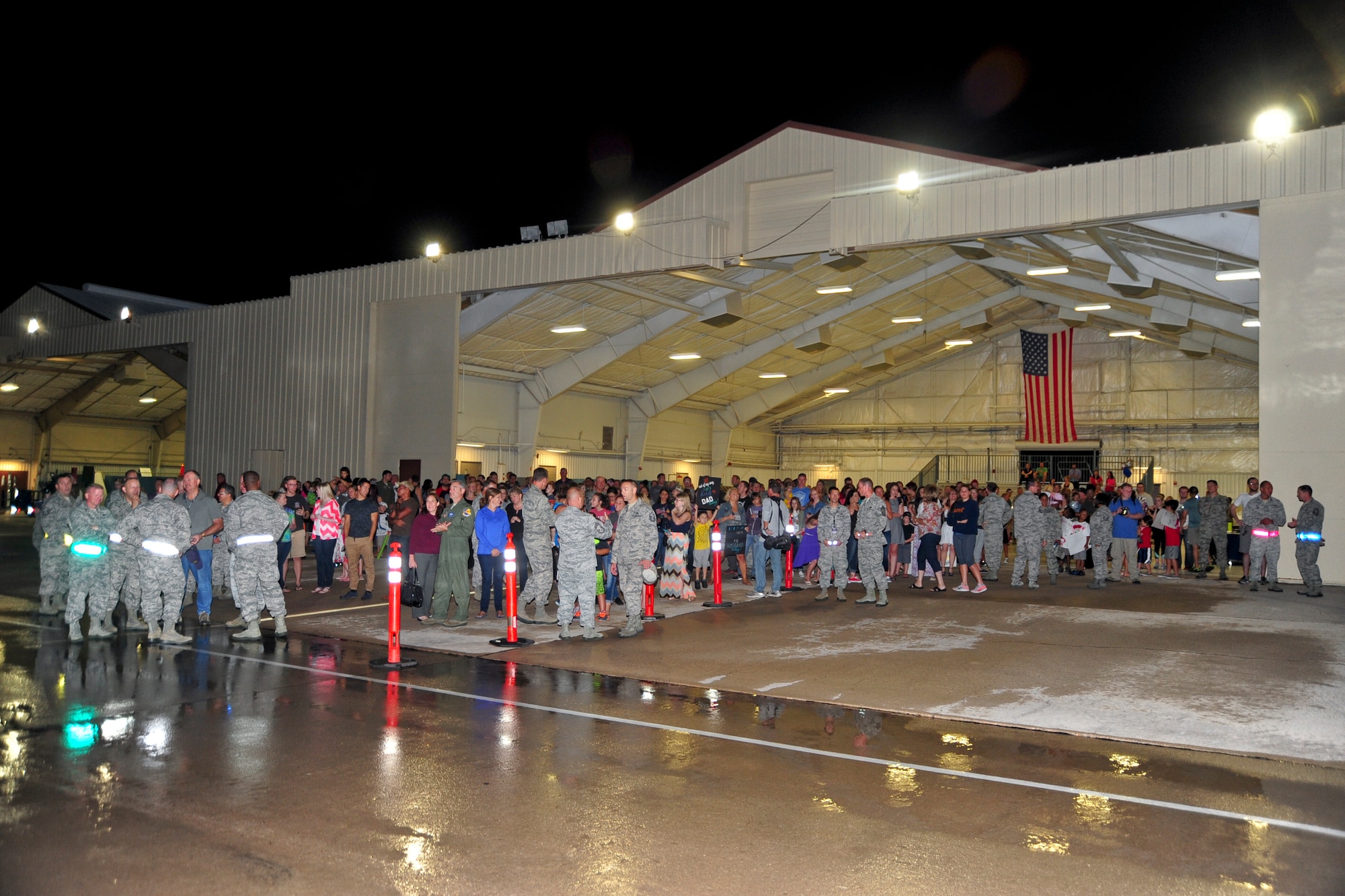 Family, friends and 355th Fighter Wing senior leaders wait on the flightline at Davis-Monthan Air Force Base, Ariz., July 29, 2015, to welcome home Airmen from a six month deployment to Europe. This is D-M’s largest deployment with 1,200 Airmen across D-M having deployed around the world. (U.S. Air Force photo by Senior Airman Chris Massey/Released) 