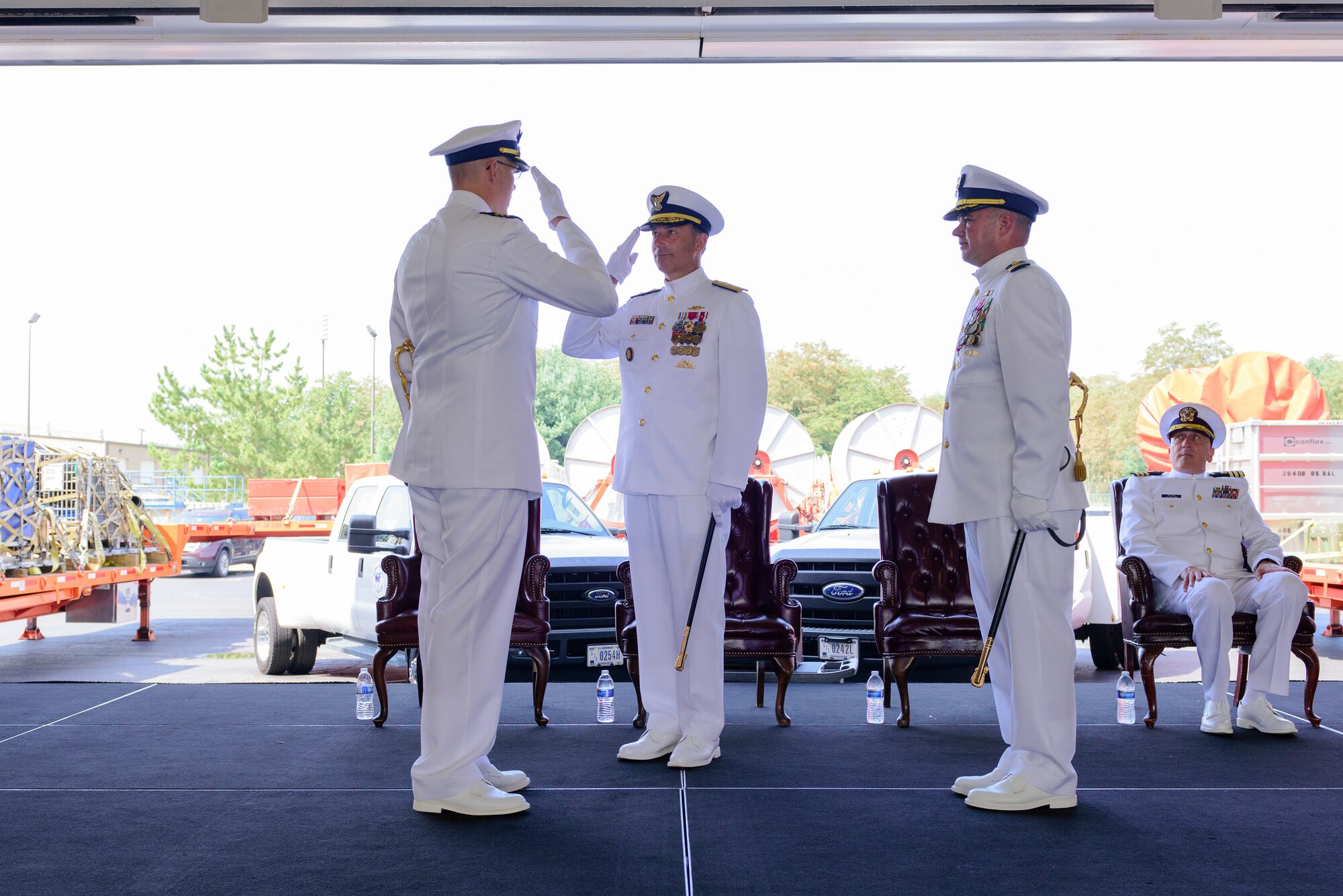 U.S. Coast Guard Cmdr. Tedd Hutley renders a salute to Rear Adm. Pat DeQuattro, Coast Guard Atlantic Area deputy commander, as he assumes command of the Atlantic Strike Team during a change of command ceremony July 29, 2015, at Joint Base McGuire-Dix-Lakehurst, N.J. Hutley relieved Cmdr. Eric Doucette who was selected for a fellowship at the Homeland Security Institute. (U.S. Air Force photo by Robert Williard/Released)