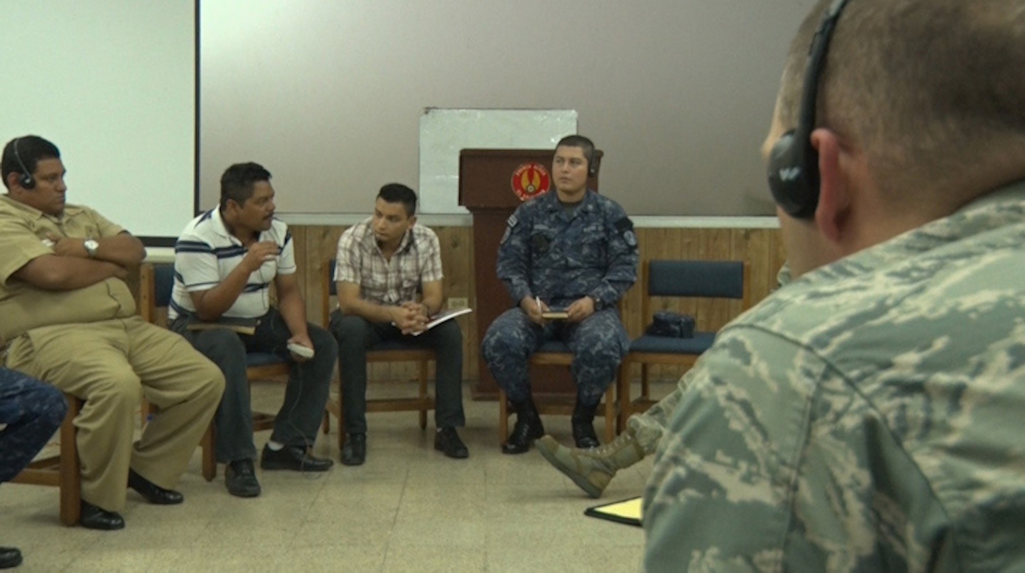U.S. Air Force Gabriel Howard (right) with the New Hampshire Air National Guard listens as  Salvadoran Navy and Salvadoran Air Force members from Joint Headquarters El Salvador discuss the intricacies of the Salvadorian military network, July 23, 2015, San Salvador.  Airmen from the 157th Communications Flight spent a week in El Salvador, July 21 through 24, discussing cybersecurity as part of the on-going New Hampshire state partnership program with El Salvador. (N.H. Air National Guard photo by Tech. Sgt. Erica Rowe)