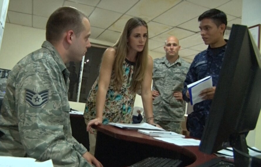 U.S. Air Force Staff Sgt. Alan Dwyer (left) and Tech. Sgt. Jeffrey Inferrere with the New Hampshire Air National Guard, discuss cybersecurity with Salvadoran Air Force Sgt. Jose Javier Alvarado Orellana, an electrician and communications technician, with the aid of translator Beatriz Bustamante, July 22, 2015, San Salvador.  The airmen spent a week in El Salvador as part of the on-going New Hampshire state partnership program with El Salvador. (N.H. Air National Guard photo by Tech. Sgt. Erica Rowe) 