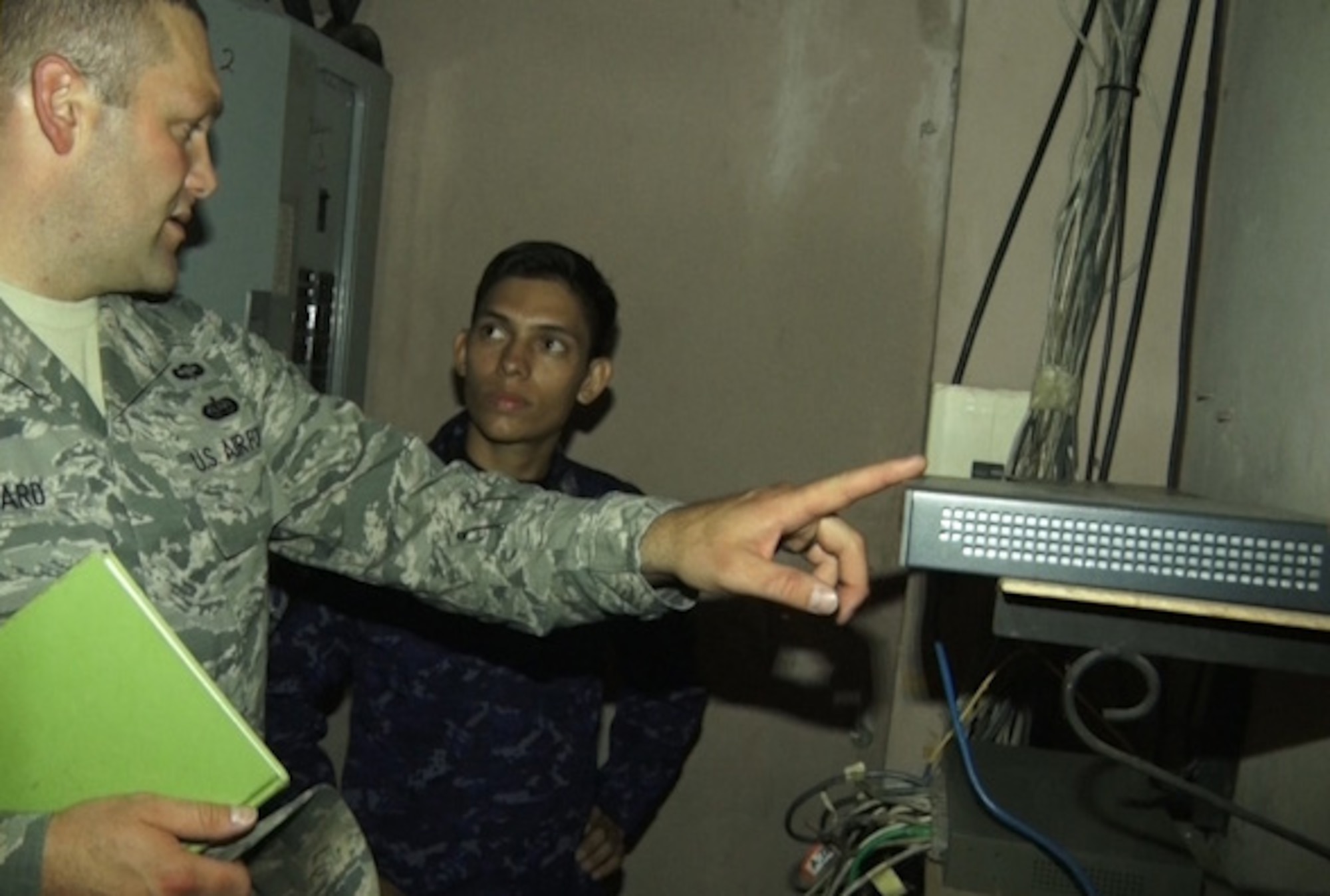 U.S. Air Force Tech. Sgt. Gabriel Howard (left) with the New Hampshire Air National Guard and San Salvadoran Air Force Sgt. Jose Javier Alvarado Orellana assesses communication equipment, July 22, 2015, San Salvador, El Salvador. Airmen from the 157th Communications Flight spent a week in El Salvador, July 21 through 24, discussing cybersecurity as part of the on-going New Hampshire state partnership program with El Salvador. (N.H. Air National Guard photo by Tech. Sgt. Erica Rowe) 