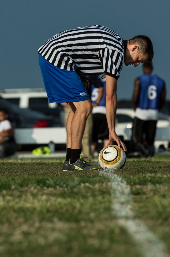 A referee places a ball at center field prior to the start of the 2015 Intramural Soccer Championship game at Langley Air Force Base, Va., July, 28, 2015. Teams from various units on the installation competed during the season, but the 633rd Medical Group and Civil Engineer Squadron made it to the championship. (U.S. Air Force photo by Senior Airman Kayla Newman/Released)
