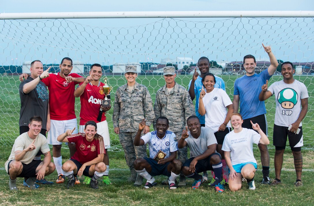 U.S. Air Force Airmen from the 633rd Medical Group pose with Col. Caroline Miller, 633rd Air Base Wing commander, and Chief Master Sgt. Mark Hurst, 633rd ABW command chief, at Langley Air Force Base, Va., July, 28, 2015. The 633rd MDG defeated the 633rd Civil Engineer Squadron in the 2015 Intramural Soccer Championship game. (U.S. Air Force photo by Senior Airman Kayla Newman/Released)
