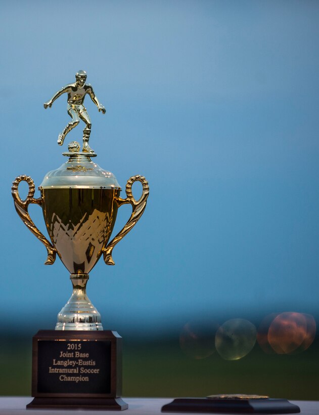 After months of playing, the 633rd Medical Group and Civil Engineer Squadron competed in the 2015 Intramural Soccer Championship game at Langley Air Force Base, Va., July 28, 2015. The 633rd MDG took home the trophy, presented by U.S. Air Force Col. Caroline Miller, 633rd Air Base Wing commander. (U.S. Air Force photo by Senior Airman Kayla Newman/Released)