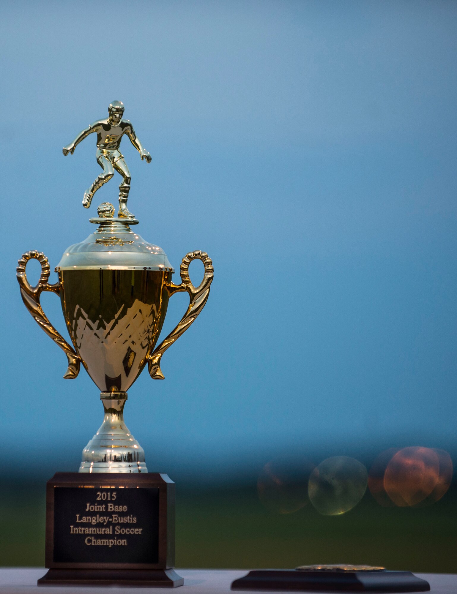 After months of playing, the 633rd Medical Group and Civil Engineer Squadron competed in the 2015 Intramural Soccer Championship game at Langley Air Force Base, Va., July 28, 2015. The 633rd MDG took home the trophy, presented by U.S. Air Force Col. Caroline Miller, 633rd Air Base Wing commander. (U.S. Air Force photo by Senior Airman Kayla Newman/Released)