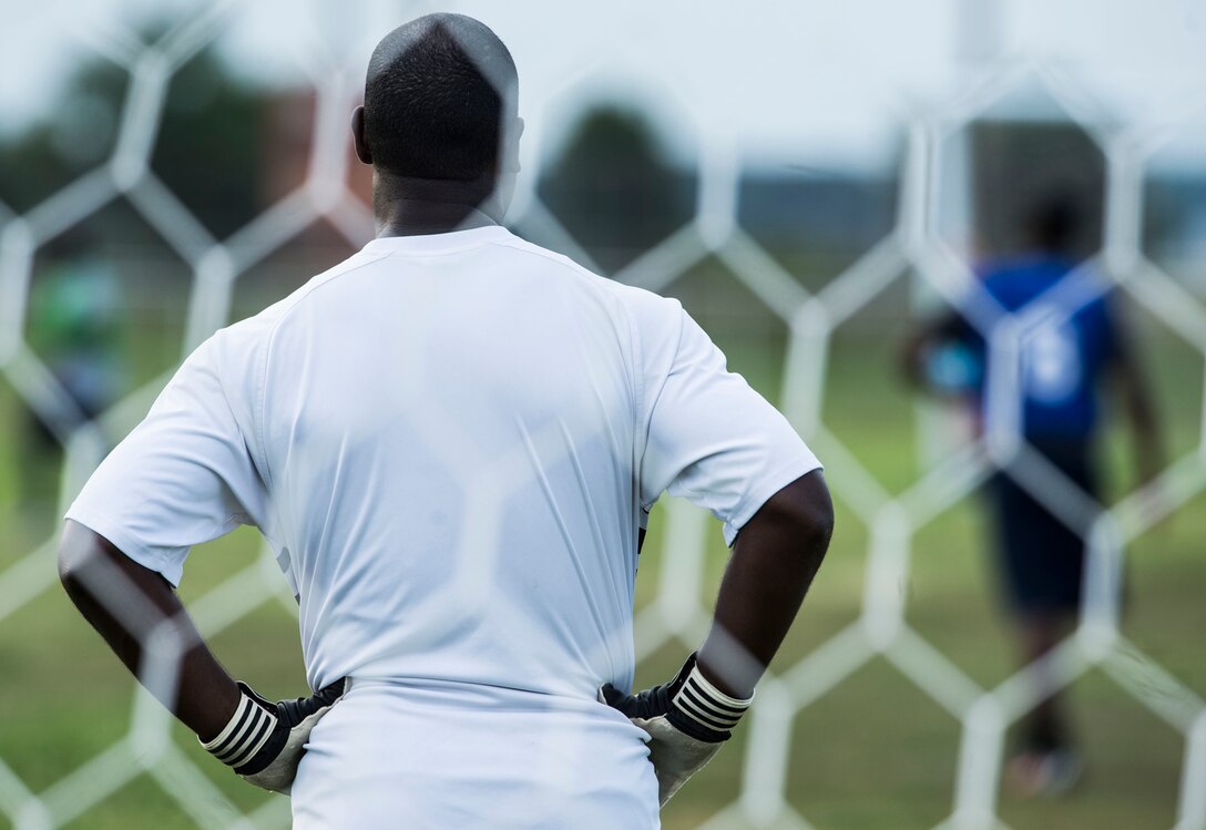 U.S. Air Force Senior Master Sgt. Ralph Oliver, 633rd Civil Engineer Squadron first sergeant and team goalkeeper, participates in the 2015 Intramural Soccer Championship game at Langley Air Force Base, Va., July 28, 2015. Intramural sports bring different units together from across base to boost morale and promote a “fit to fight” Air Force. (U.S. Air Force photo by Senior Airman Kayla Newman/Released)