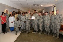 Staff Sgt. Adaultha Lewis, center, 47th Medical Operations Squadron flight medicine NCOIC, poses with Col. Thomas Shank, center-left, 47th Flying Training Wing commander, and Chief Master Sgt. Teresa Clapper, 47th FTW command chief, after accepting the “XLer of the Week” award, here, July 22, 2015. The “XLer” is a weekly award chosen by wing leadership and is presented to those who consistently make outstanding contributions to their unit and Laughlin. (U.S. Air Force photo by Airman 1st Class Brandon May)