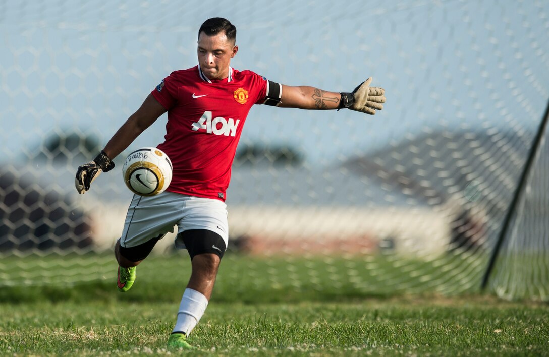 U.S. Air Force Staff Sgt. Andres Martinez, 633rd Medical Group team captain, clears the ball during 2015 Intramural Soccer Championship game at Langley Air Force Base, Va., July 28, 2015. The third seed 633rd MDG won the game, beating the second seed 633rd Civil Engineer Squadron. (U.S. Air Force photo by Senior Airman Kayla Newman/Released))