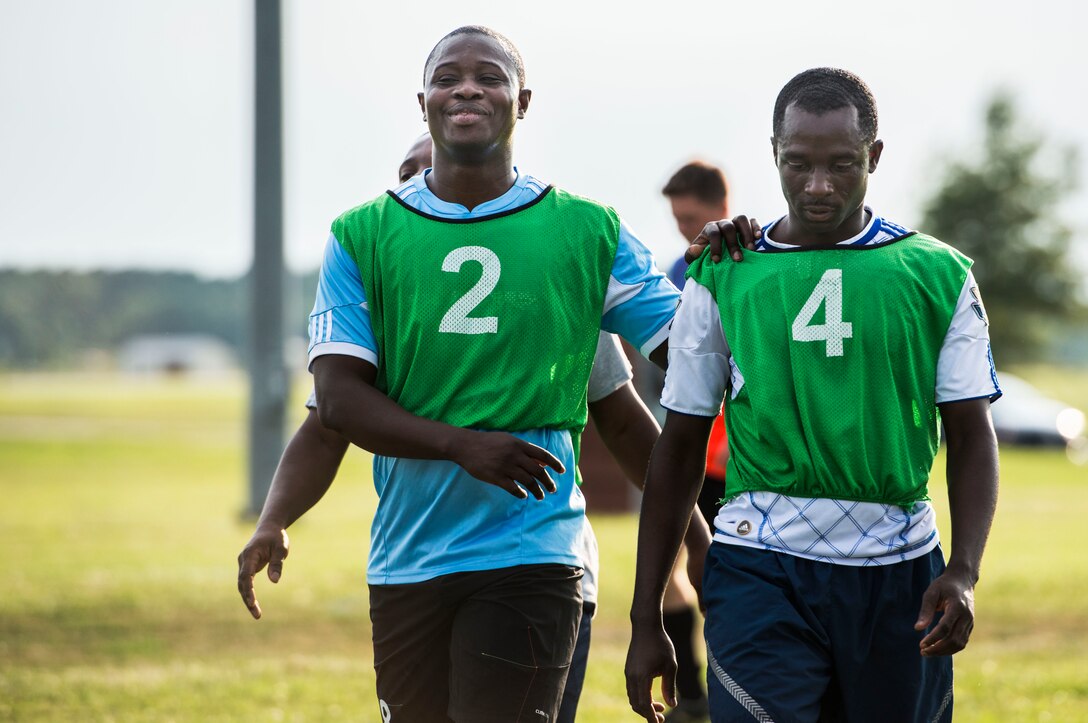 U.S. Air Force Airmen assigned to the 633rd Medical Group prepare for the 2015 Intramural Soccer Championship game at Langley Air Force Base, Va., July 28, 2015. After the match, Airman 1st Class Charles Essel, jersey number 4, won the most outstanding player award for his performance in the game. (U.S. Air Force photo by Senior Airman Kayla Newman/Released)
