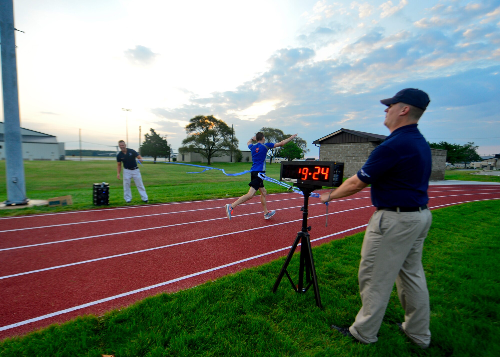 First Lt. Kory Cookson, 9th Airlift Squadron C-5M Super Galaxy pilot, sprints through the finish line, winning the 5K Warrior Run July 30, 2015, at Dover Air Force Base, Del. Cookson finished with a time of 19:24. (U.S. Air Force photo/Airman 1st Class William Johnson)