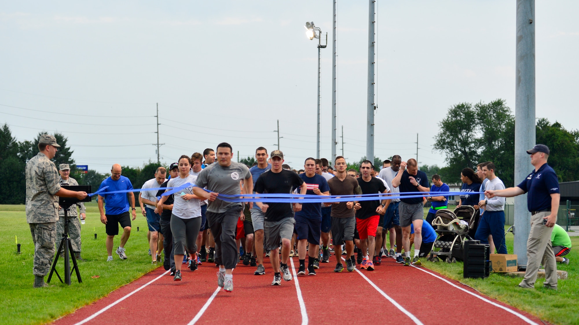 Team Dover Airmen sprint through the starting line of the 5K Warrior Run July 30, 2015, at the track on Dover Air Force Base, Del. The track reopened after undergoing a nine month renovation project and is built in accordance with International Association of Athletics Federations’ standards. (U.S. Air Force photo/Airman 1st Class William Johnson)