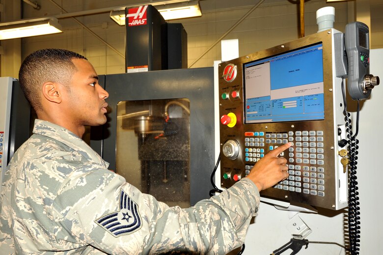 Tech. Sgt. Joshua Briscoe, 69th Maintenance Squadron metals technology craftsman, operates a Computer Numerical Control (CNC) machine, which cuts shapes out of sheets of metal. Briscoe was named Warrior of the Week for the fifth week of July, 2015. (U.S. Air Force photo/Staff Sgt. Susan L. Davis)