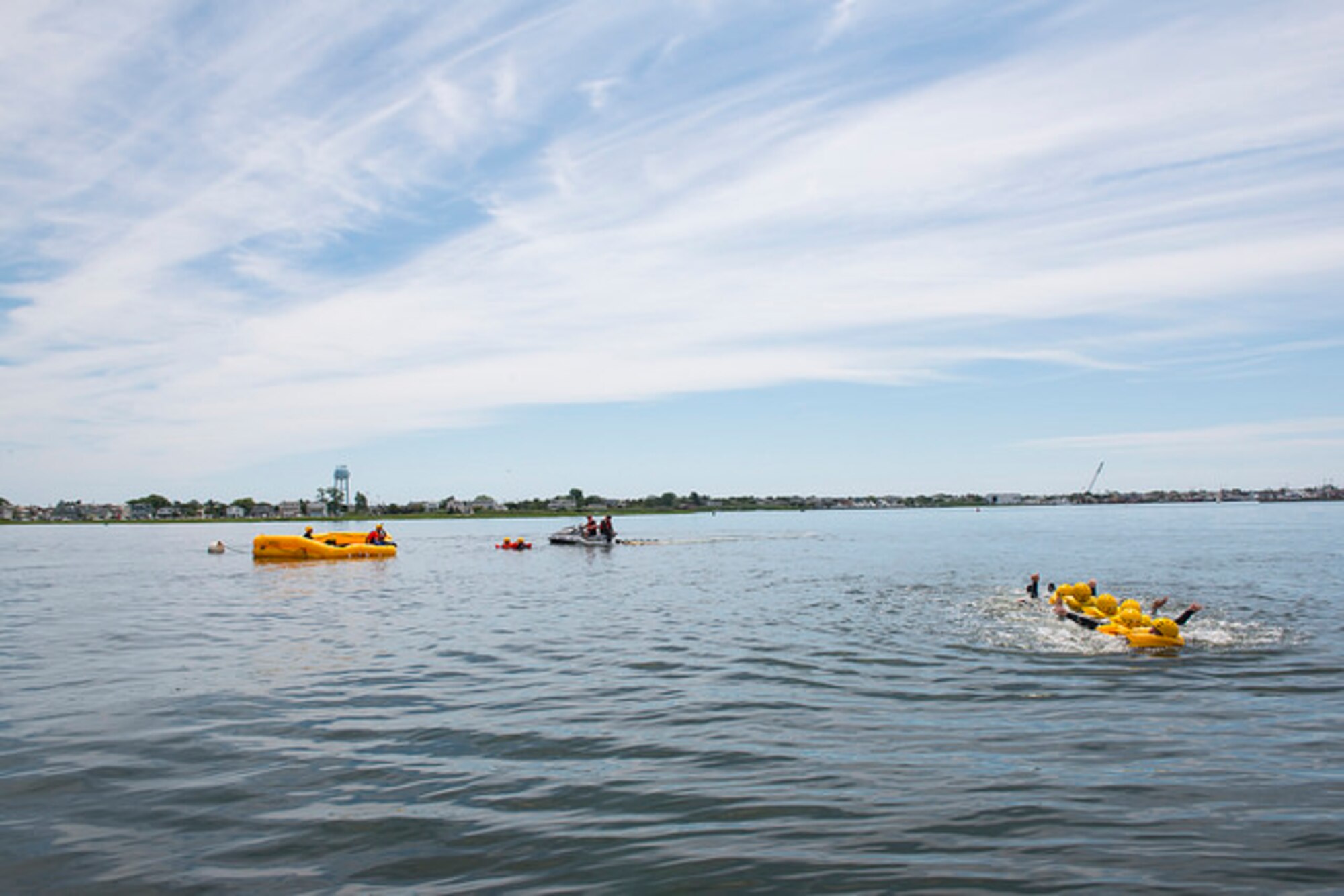 Members of the 305th Air Mobility Wing link up and swim together during water survival training in Barnegat, N.J. July 23, 2015. Water survival training is mandatory once every three years and focuses on teaching aircrews what to do when an aircraft goes down in the water, from proper use of flotation devices to all procedures and equipment involved with the life rafts in the aircraft. (U.S. Air Force photo by Airman 1st Class Joshua King/ released)