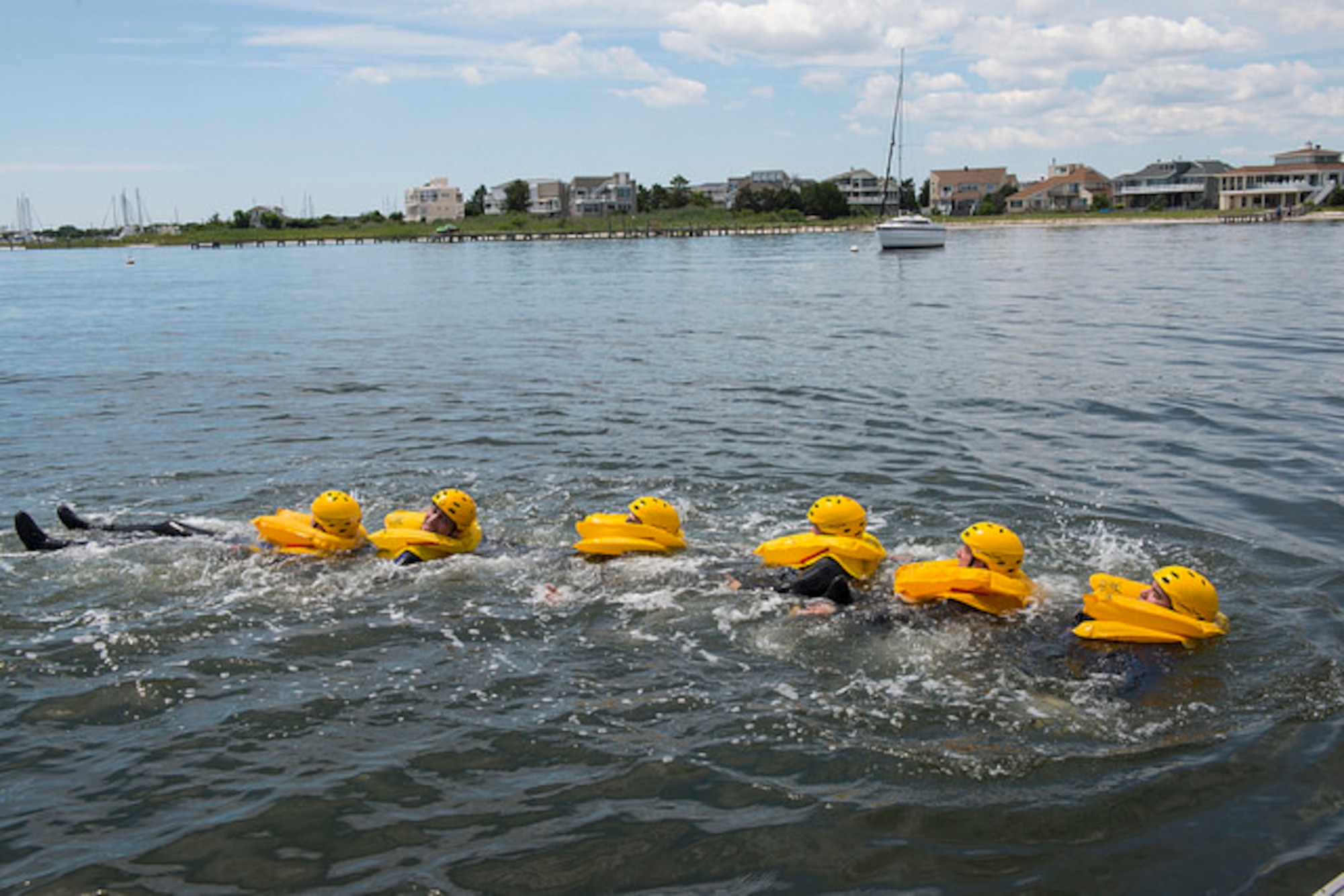 Members of the 305th Air Mobility Wing link up and swim together during water survival training in Barnegat, N.J. July 23, 2015. Water survival training is mandatory once every three years and focuses on teaching aircrews what to do when an aircraft goes down in the water, from proper use of flotation devices to all procedures and equipment involved with the life rafts in the aircraft. (U.S. Air Force photo by Airman 1st Class Joshua King/ released)