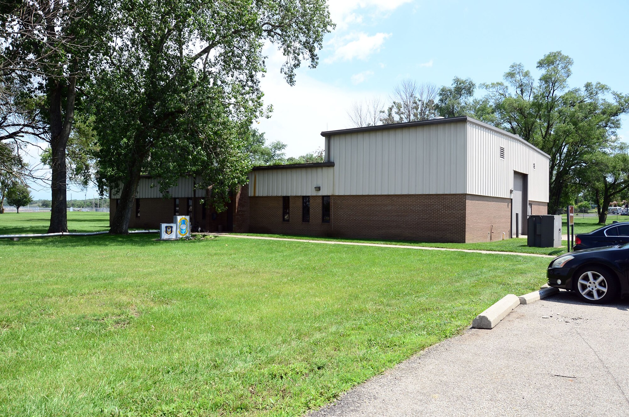 WRIGHT-PATTERSON AIR FORCE BASE, Ohio - The 87th Aerial Port Squadron won Facility of the Month for the month of July. The 445th Airlift Wing's First Sergeants Council evaluates eight buildings around the wing during the Scarlet unit training assemblies July to October. The first sergeants base their criteria on lawn care, clean walkways and driveways and aesthetics, such as creative touches to show personality. The 87th APS proudly displays their squadron shield at the entrance to their building. (U.S. Air Force photo/Senior Airman Joel McCullough)