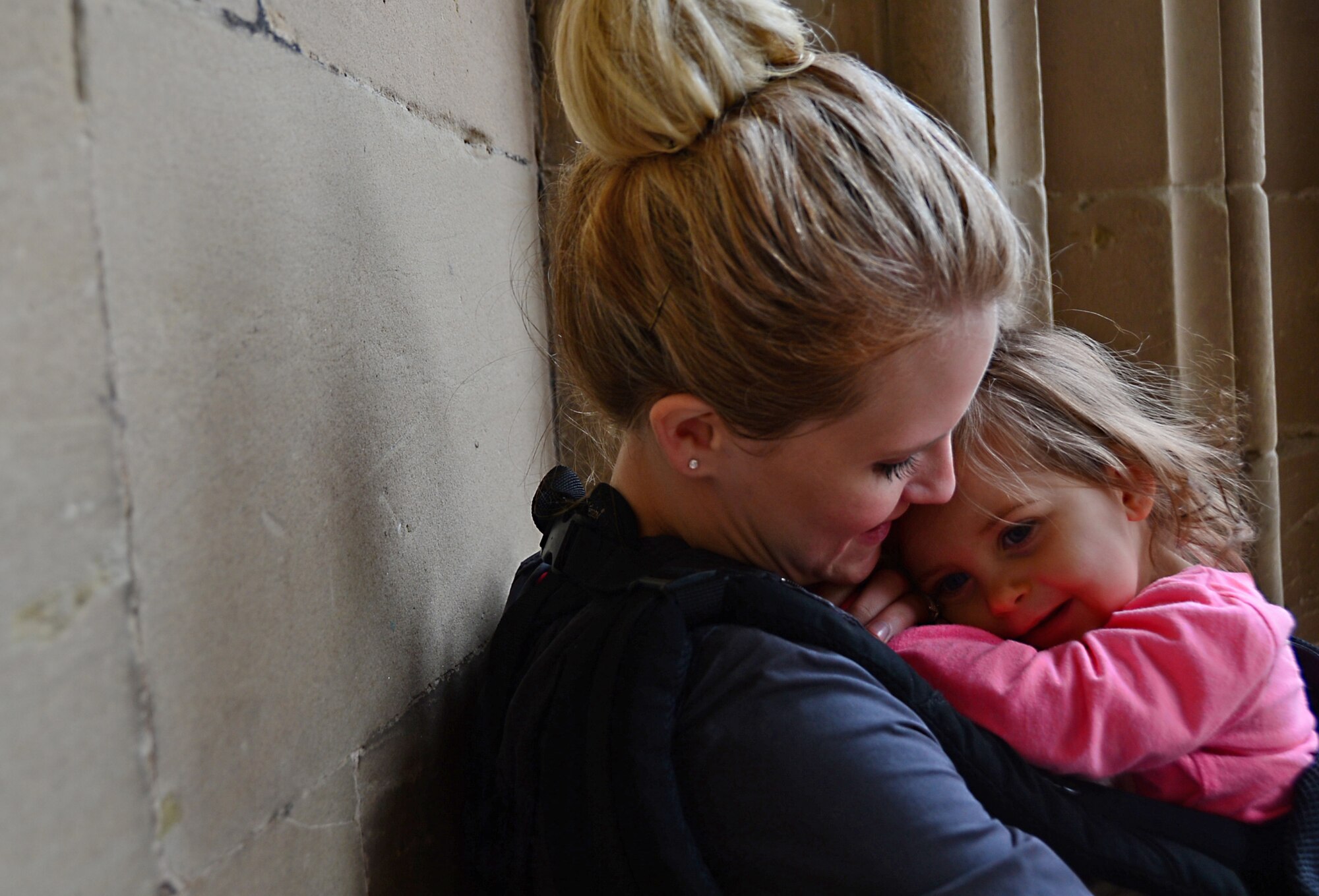 Rachel Reed, wife of Senior Airman David Reed, 48th Civil Engineer Squadron water and fuel systems maintenance journeyman, holds her daughter, Addie, at Warwick Castle, England, during a deployed spouses trip July 24, 2015. The Comprehensive Airman Fitness program and the 48th Fighter Wing Chaplain Corps hosted the trip to provide spouses with the opportunity to interact with other families and explore the local community. (U.S. Air Force photo by Senior Airman Erin O’Shea/Released)
