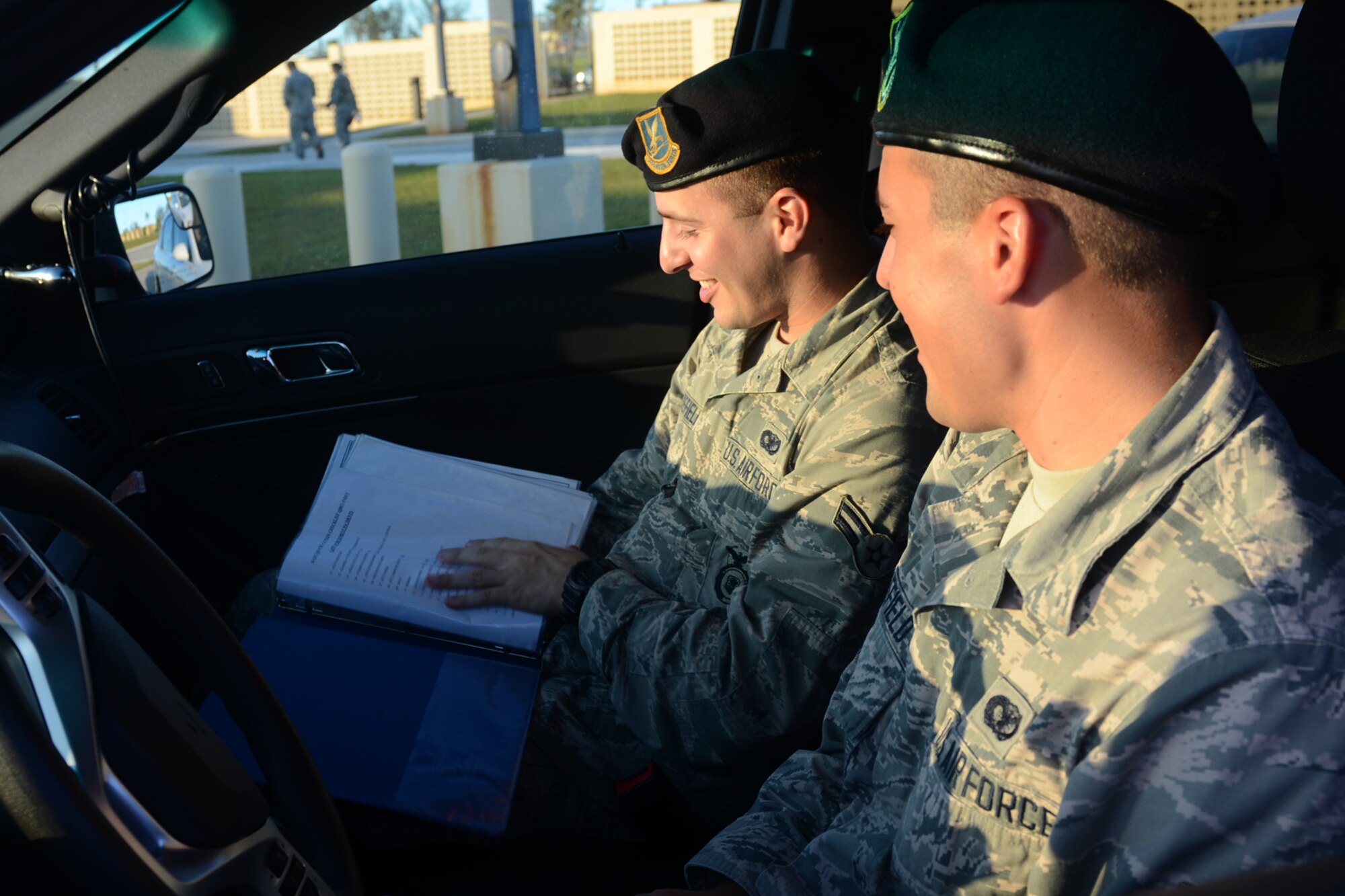Airmen 1st Class Travis (left) and Colby Wakefield, 36th Security Forces Squadron entry controllers, prepare for a shift together July 29, 2015, at Andersen Air Force Base, Guam. While they are brothers in arms who serve together, they are also fraternal twins who have worked together since entering the Air Force in October 2013. (U.S. Air Force photo by Airman 1st Class Alexa Ann Henderson/Released)