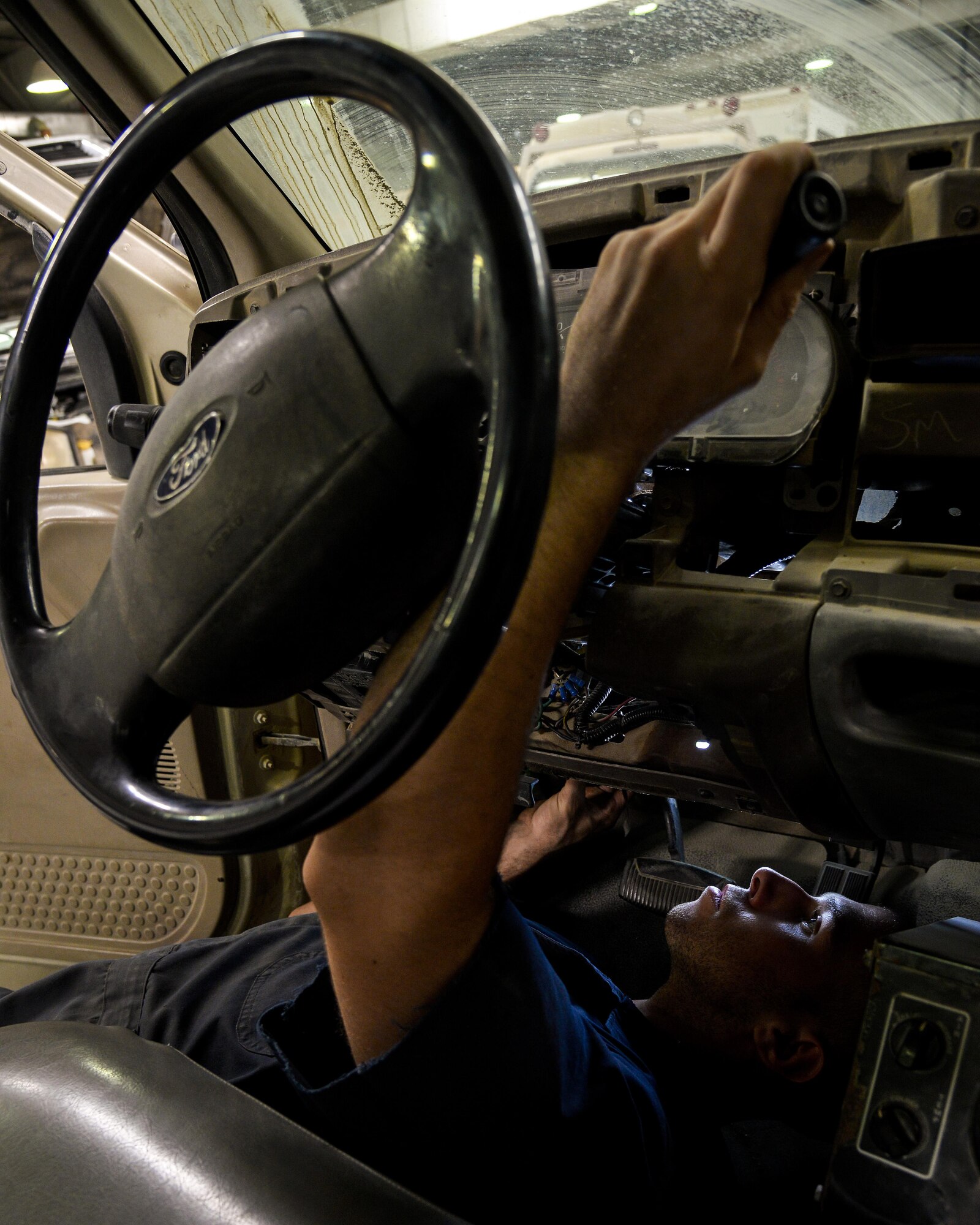 Senior Airman Nathan installs a shift tube on a truck at an undisclosed location in Southwest Asia July 17, 2015. SrA Nathan is a vehicle mechanic assigned to the 380th Expeditionary Logistics Readiness Squadron. (U.S. Air Force photo/Tech. Sgt. Christopher Boitz)