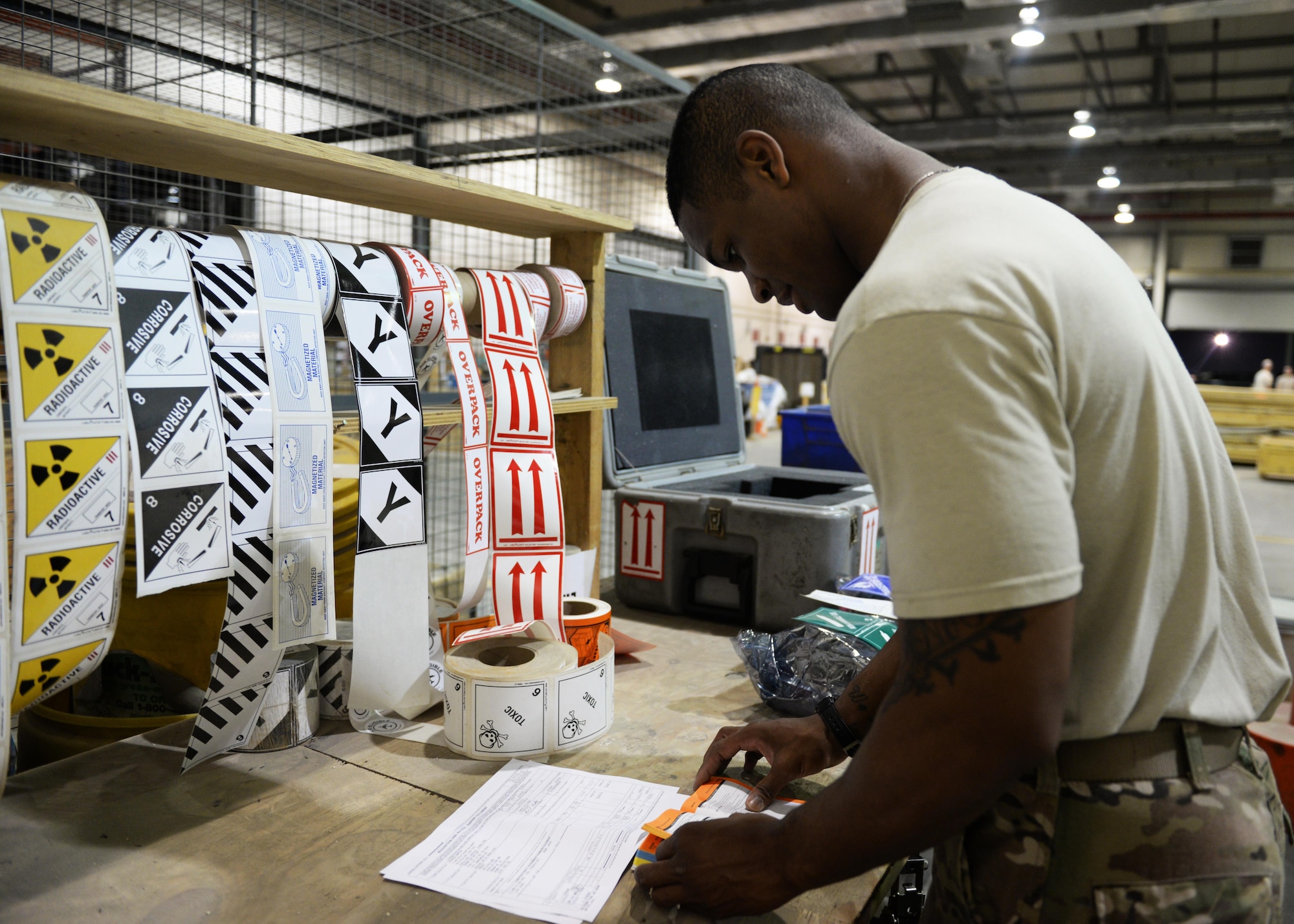 U.S. Air Force Senior Airman Kionne Lewis, 455th Expeditionary Logistics Readiness Squadron’s Traffic Management Office cargo movement specialist, prepares to label material to be shipped out to Al Udied, Air Base, Qatar, July 21, 2015, at Bagram Airfield, Afghanistan. Lewis and his team are responsible for ensuring all shipments from the AOR, to include hazardous and classified materials as well as aircraft parts, are ready for transport. (U.S. Air Force photo by Senior Airman Cierra Presentado/Released)