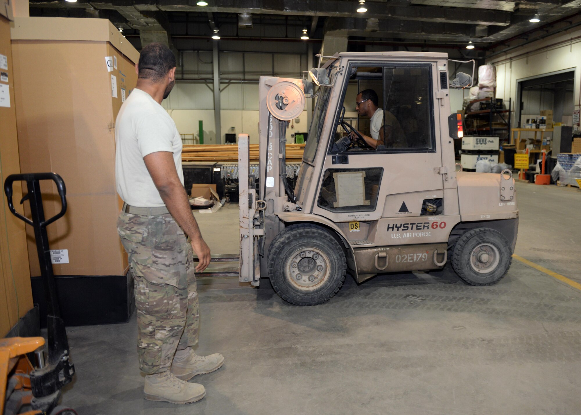 U.S. Airmen from the 455th Expeditionary Logistics Readiness Squadron Traffic Management Office bring in new material July 21, 2015, at Bagram Airfield, Afghanistan. The team is responsible for ensuring all shipments from the AOR to include hazardous and classified materials as well as aircraft parts are ready for transport. (U.S. Air Force photo by Senior Airman Cierra Presentado/Released)