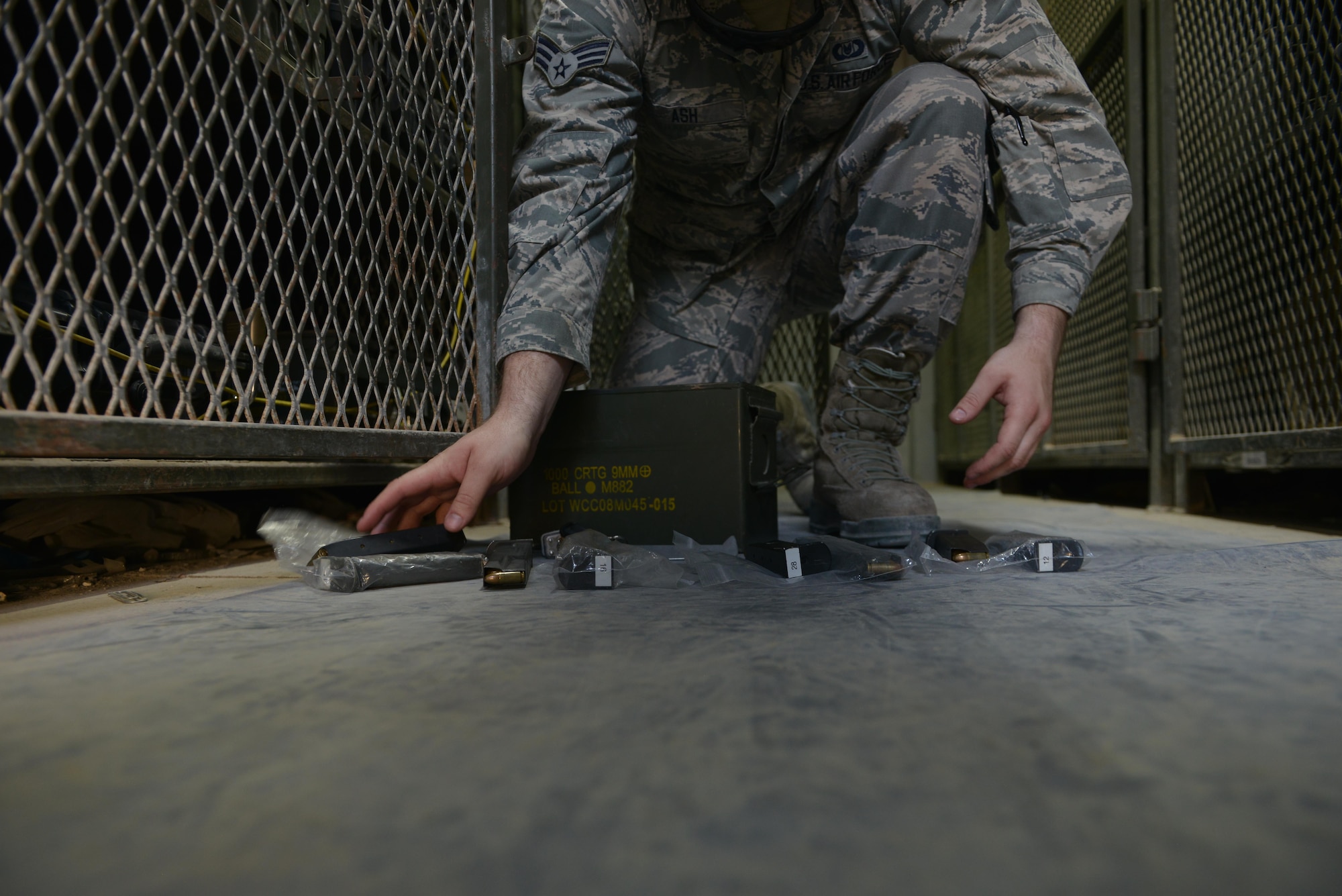 Senior Airman James Ash, 379th Expeditionary Operations Support Squadron Aircrew Flight Equipment, separates M-9 magazines for each crew member that will be armed prior to take off July 29, 2015 at Al Udeid Air Base, Qatar. AFE airmen are responsible for helmet harnesses, life preservers and parachutes.  They also ensure aircrew members are properly armed prior to takeoff and clear them after each mission. (U.S. Air Force photo/Staff Sgt. Alexandre Montes)
