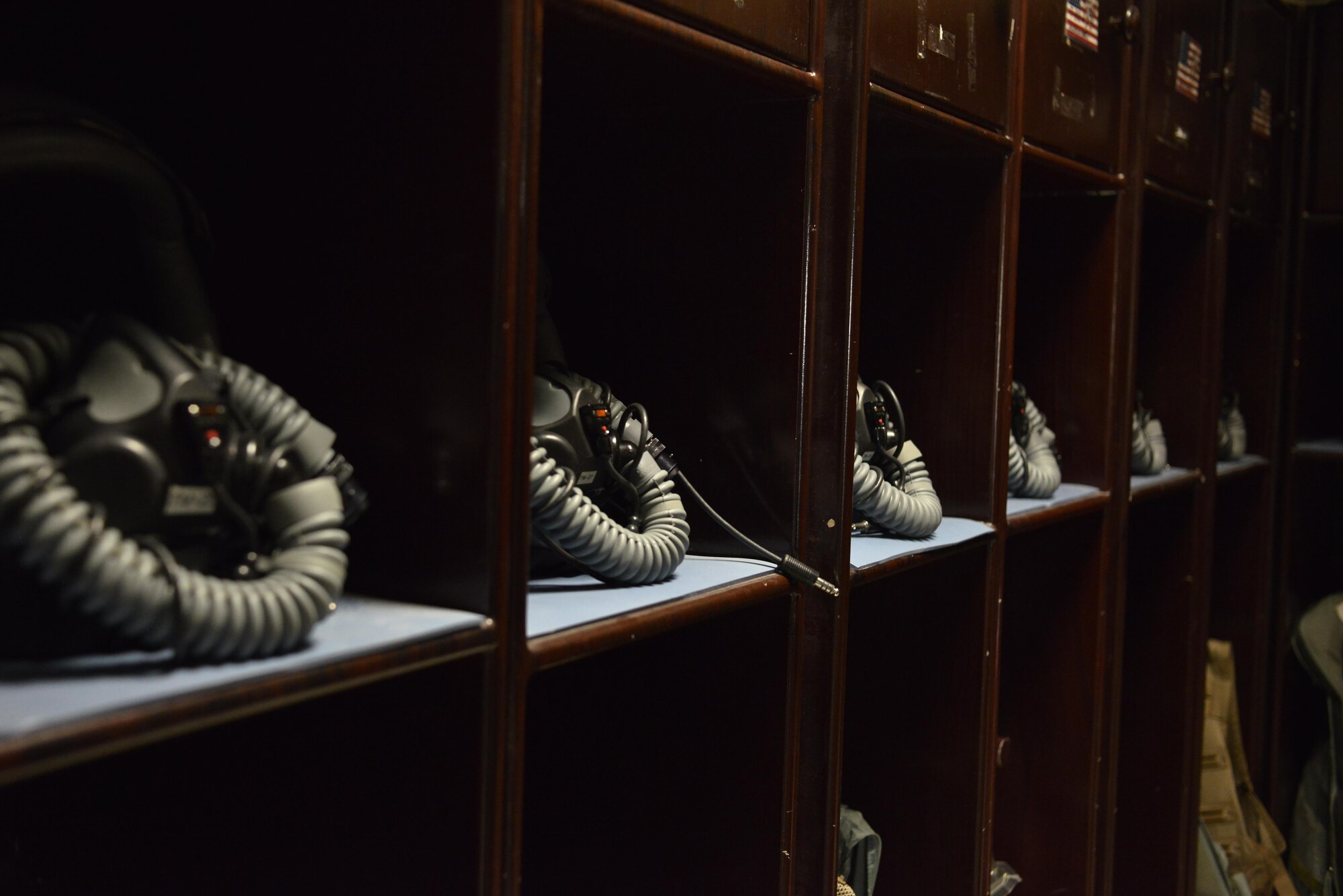 Helmets of B-1 Bomber aircrews sit in their lockers after 379th Expeditionary Operations Support Squadron Aircrew Flight Equipment airmen completed their daily maintenance and inspections July 29, 2015 at Al Udeid Air Base, Qatar. B-1 Bomber aircrews rely on AFE airmen’s proficiency to ensure proper function of helmets, life preservers, communication modules and other types of equipment used during flight or in case of an emergency. (U.S. Air Force photo/Staff Sgt. Alexandre Montes)