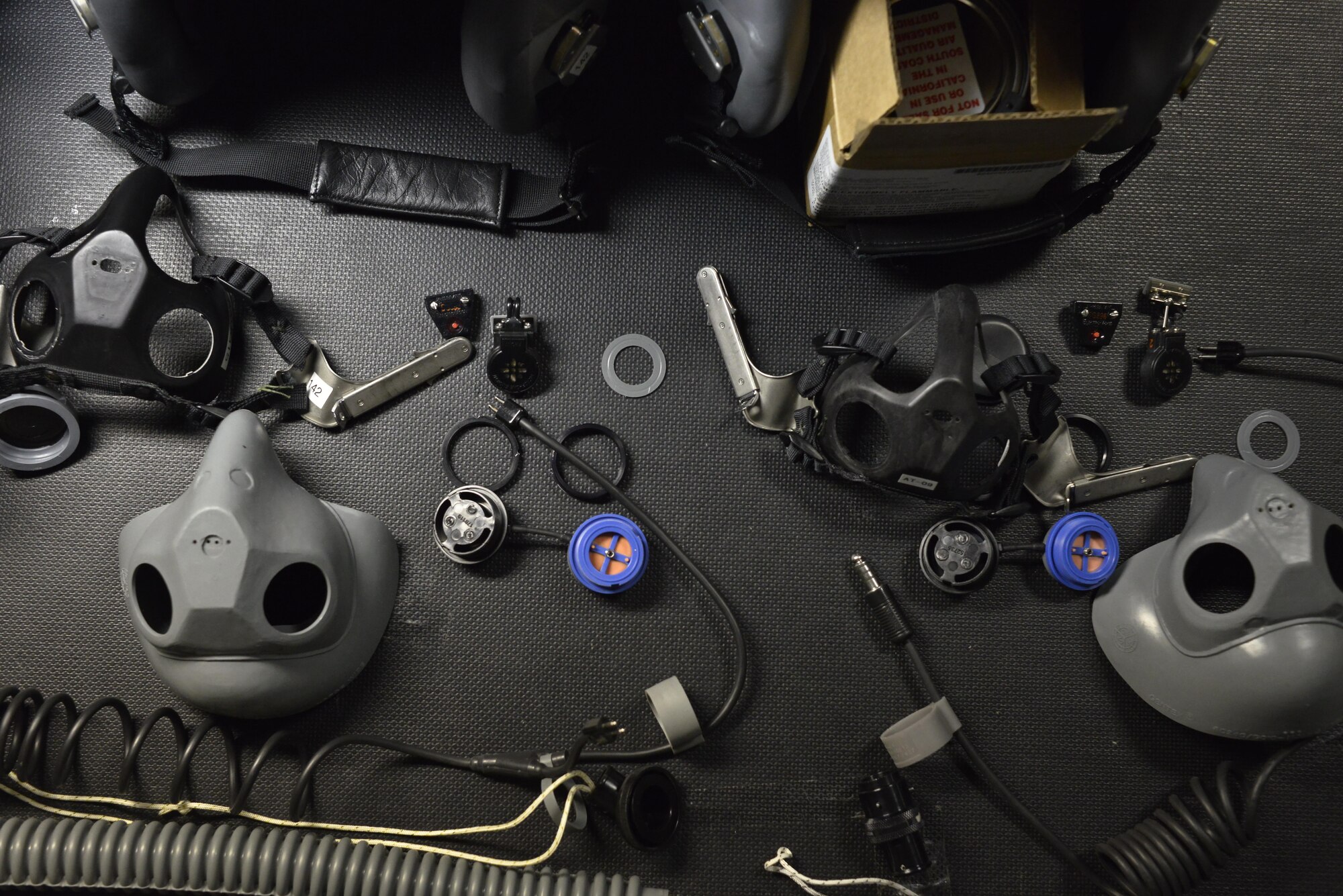 A disassembled aircrew mask waits to be inspected then re-assembled by 379th Expeditionary Operations Support Squadron Aircrew Flight Equipment airmen to proper working order for a B-1 Bomber aircrew member July 29, 2015 at Al Udeid Air Base, Qatar. B-1 Bomber aircrews rely on AFE airmen’s proficiency to ensure proper function of helmets, life preservers, communication modules and other types of equipment used during flight or in case of an emergency. (U.S. Air Force photo/Staff Sgt. Alexandre Montes)