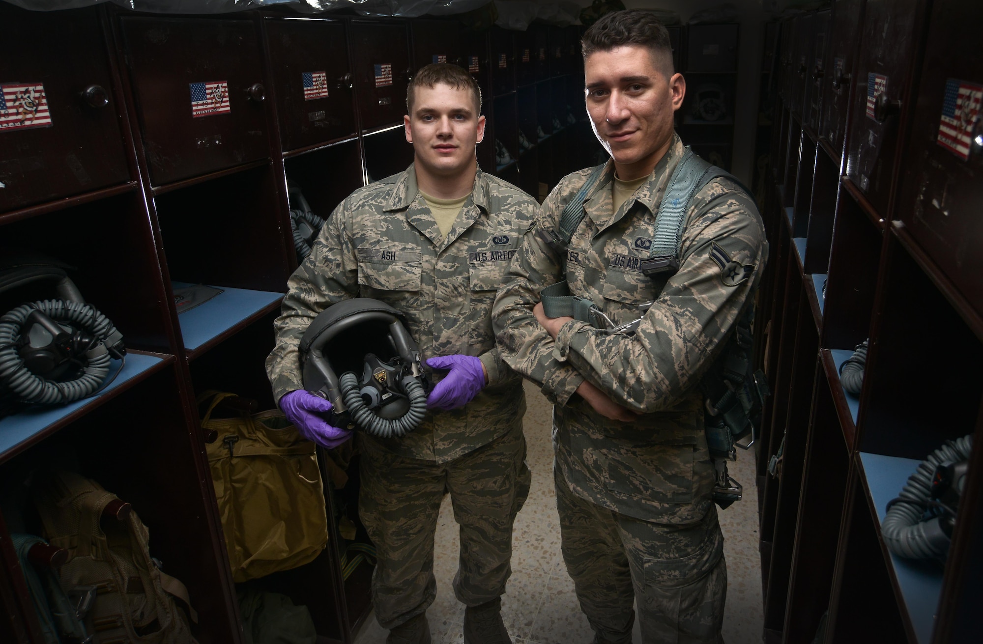 Senior Airman James Ash and Airman 1st Class Andrew Gonzalez are deployed to the 379th Expeditionary Operations Support Squadron Aircrew Flight Equipment shop from Ellsworth Air Force Base, South Dakota. Several airmen deploy with their squadron or unit to Al Udeid Air Base under the air expeditionary force structure helping standardization throughout deployment cycles. (U.S. Air Force photo/Staff Sgt. Alexandre Montes)