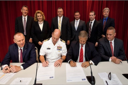 Naval Surface Warfare Center Indian Head Explosive Ordnance Disposal Technology Division (NSWC IHEODTD) Commanding Officer, Capt. Vincent Martinez (center left); Technical Director, Ashley Johnson (far left); Chemring North America President, Juan Navarro (center right); and Chemring Ordnance President Mike Quesenberry (far right) - joined by team leads from both organizations - sign certificates commemorating the command's first public-private partnership under the CITE designation.  