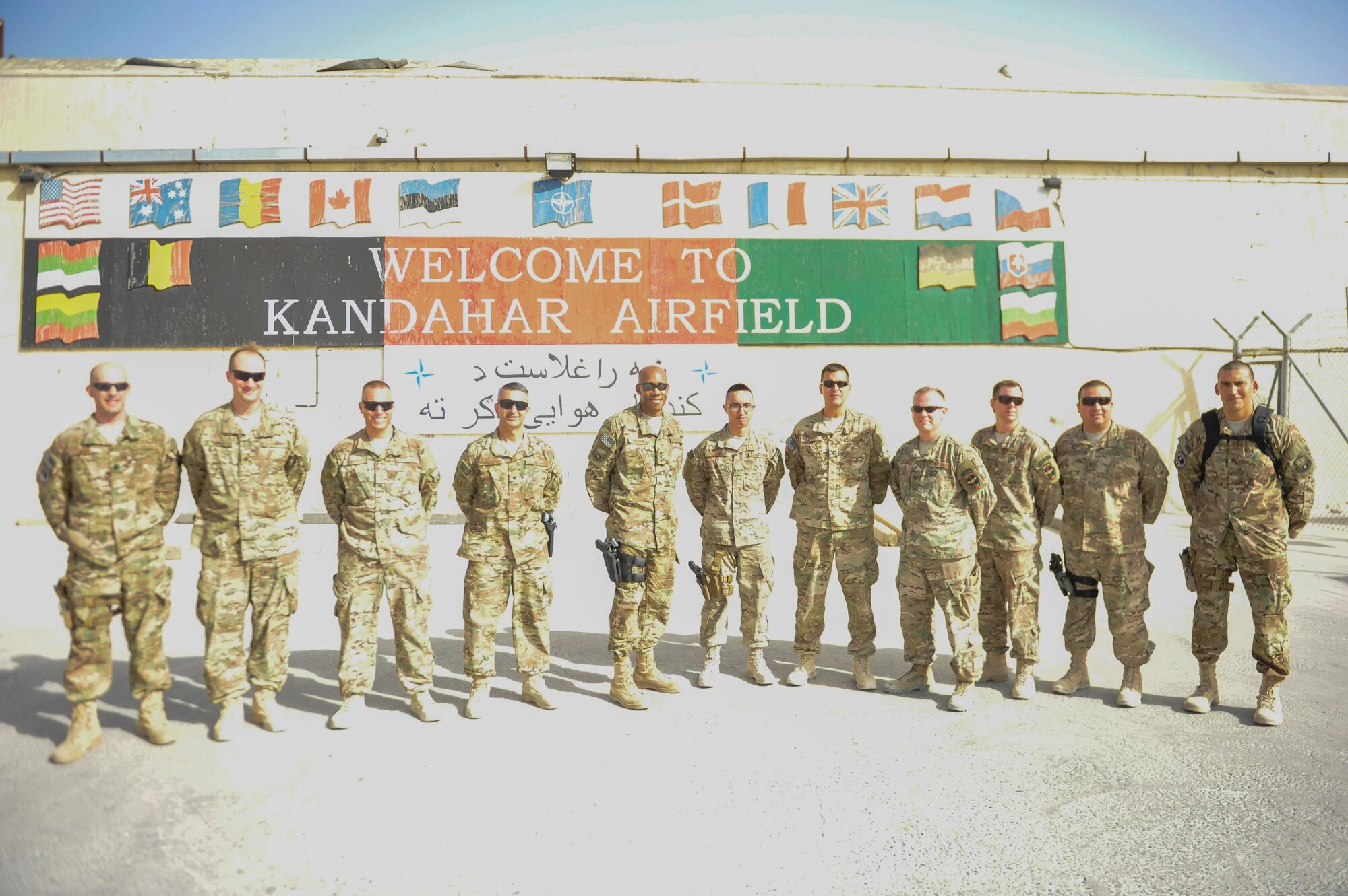 U.S. Air Force Lt. Gen. Charles Q. Brown Jr., center, U.S. Air Forces Central Command commander, takes a group photo in front of the compound known as the Taliban’s Last Stand at Kandahar Airfield, Afghanistan, July 25, 2015. In December 2001, Afghan forces supported by U.S. military advisors and air support drove Taliban forces from the area, giving this building its famous nickname. Brown met with Airmen from Bagram Airfield and KAF during his tour of Afghanistan and got a first-hand look at how Airmen support the mission in Afghanistan. (U.S. Air Force photo by Maj. Tony Wickman/Released)