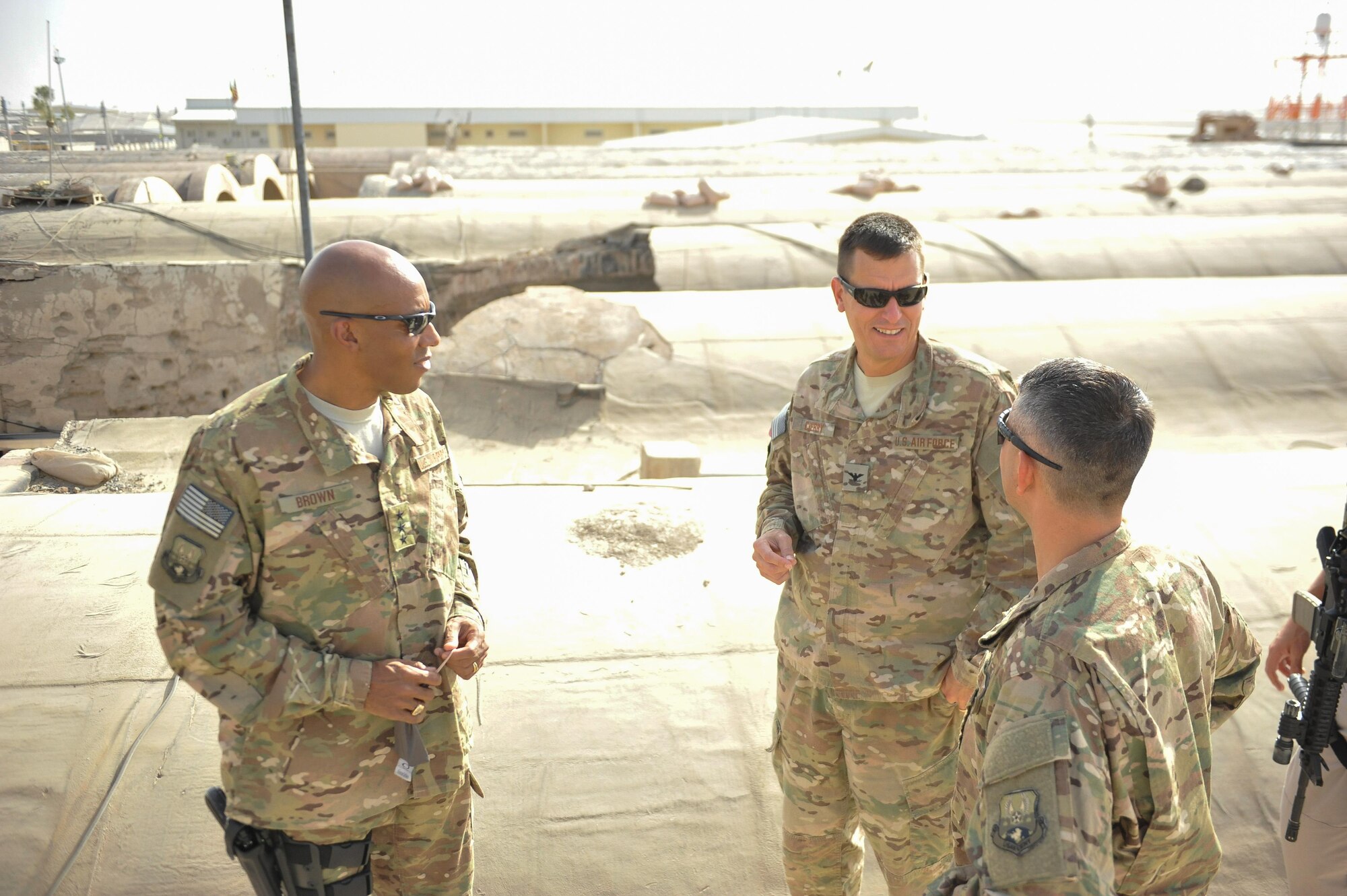 U.S. Air Force Lt. Gen. Charles Q. Brown Jr., U.S. Air Forces Central Command commander, and Brig. Gen. Dave Julazadeh, 455th Air Expeditionary Wing commander, listens to Col. Rhude Cherry, center, 451st Air Expeditionary Group commander, explain how the compound known as the Taliban’s Last Stand was damaged at Kandahar Airfield, Afghanistan, July 25, 2015. In December 2001, Afghan forces supported by U.S. military advisors and air support drove Taliban forces from the area, giving this building its famous nickname. Brown met with Airmen from Bagram Airfield and KAF during his tour of Afghanistan and got a first-hand look at how Airmen support the mission in Afghanistan. (U.S. Air Force photo by Maj. Tony Wickman/Released)