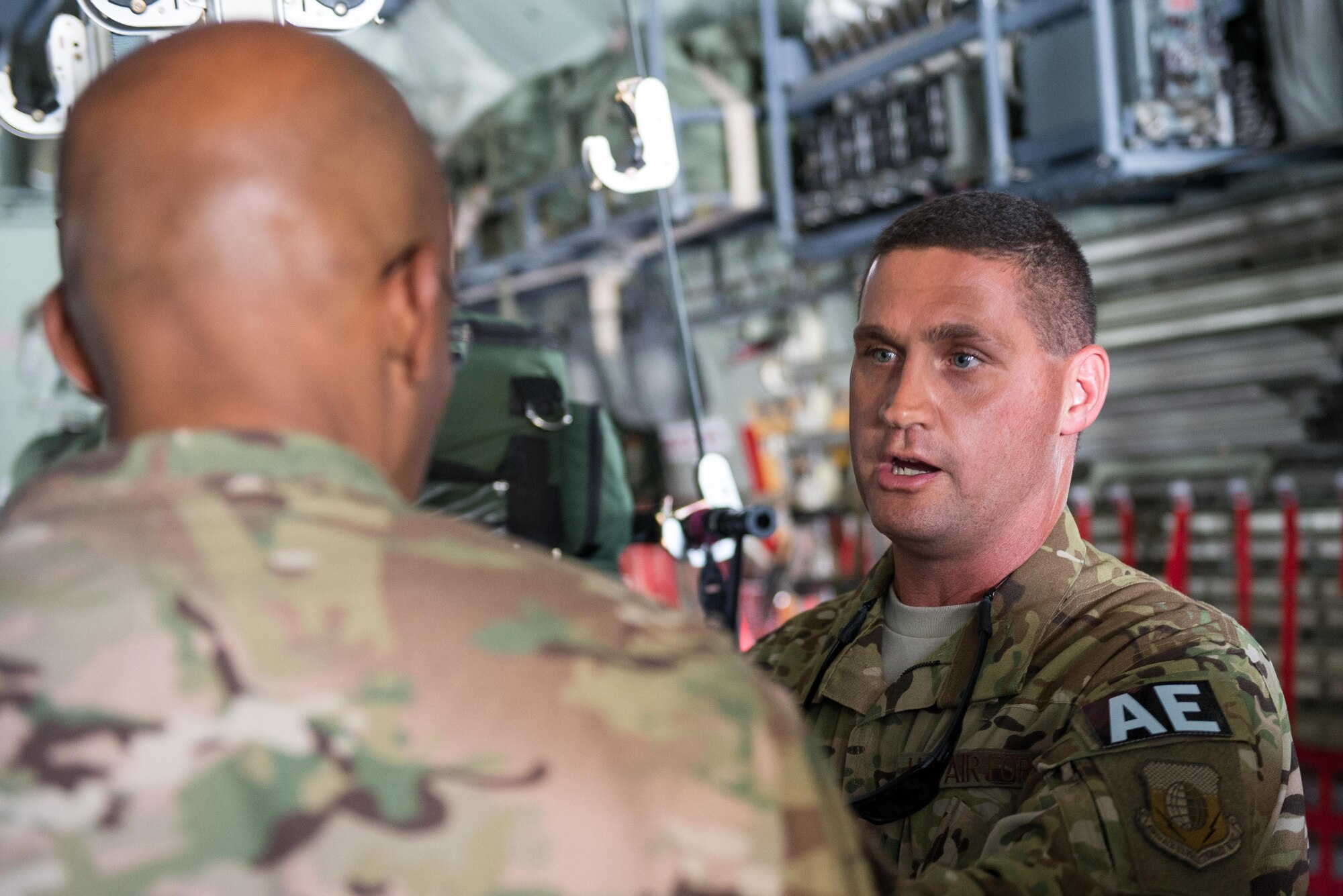 U.S. Air Force Lt. Gen. Charles Q. Brown Jr., U.S. Air Forces Central Command commander, speaks with Tech. Sgt. Russell McLamb, 455th Expeditionary Aeromedical Evacuation Squadron at Bagram Airfield, Afghanistan, July 25, 2015. Brown met with Airmen from BAF and Kandahar Airfield during his tour of Afghanistan and got a first-hand look at how Airmen support the mission in Afghanistan. (U.S. Air Force photo by Tech. Sgt. Joseph Swafford/Released)