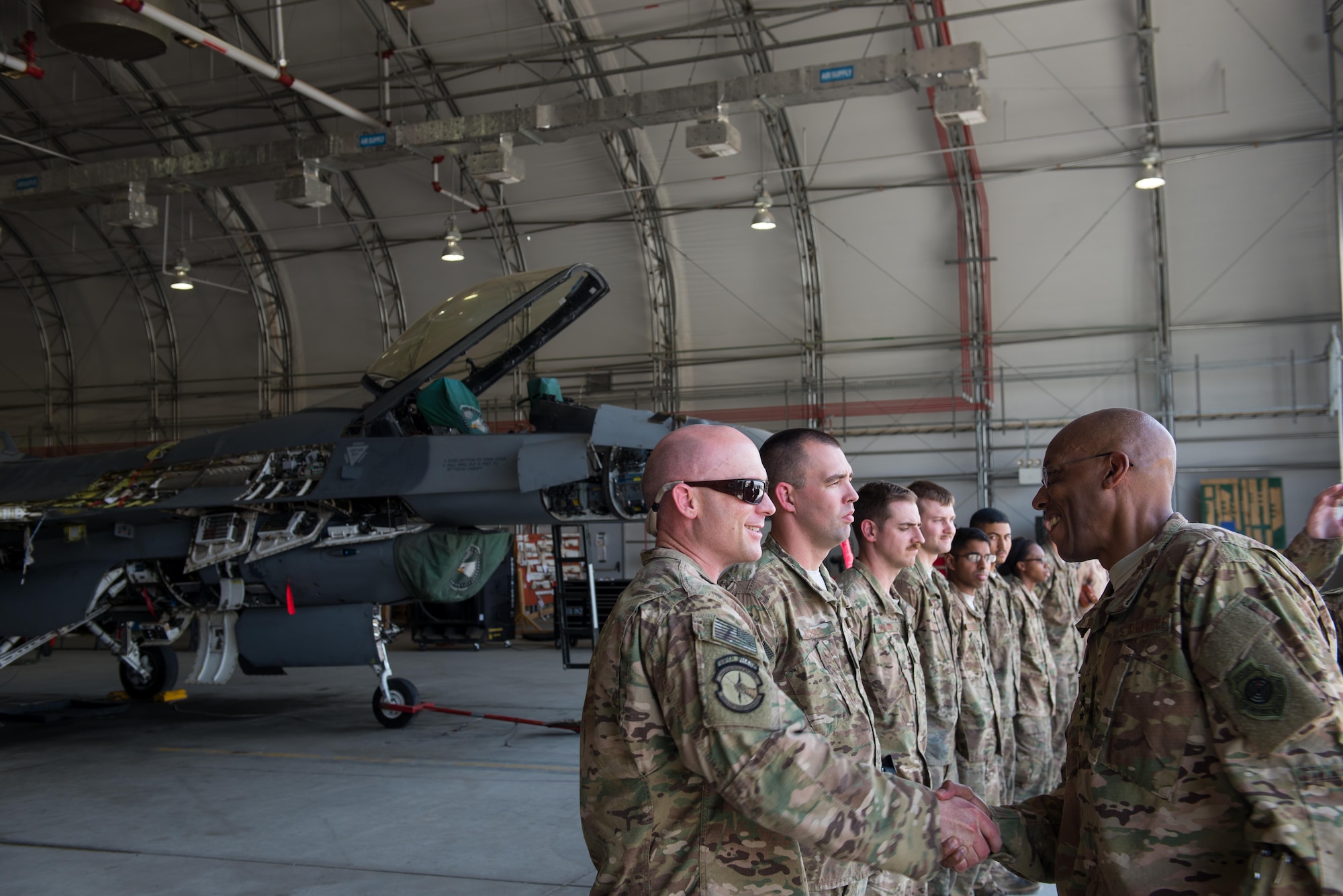 U.S. Air Force Lt. Gen. Charles Q. Brown Jr., U.S. Air Forces Central Command commander, shakes hands with Master Sgt. Aaron Lerding, 455th Expeditionary Maintenance Squadron maintenance flight chief at Bagram Airfield, Afghanistan, July 25, 2015. Brown met with Airmen from BAF and Kandahar Airfield during his tour of Afghanistan and got a first-hand look at how Airmen support the mission in Afghanistan. (U.S. Air Force photo by Tech. Sgt. Joseph Swafford/Released)