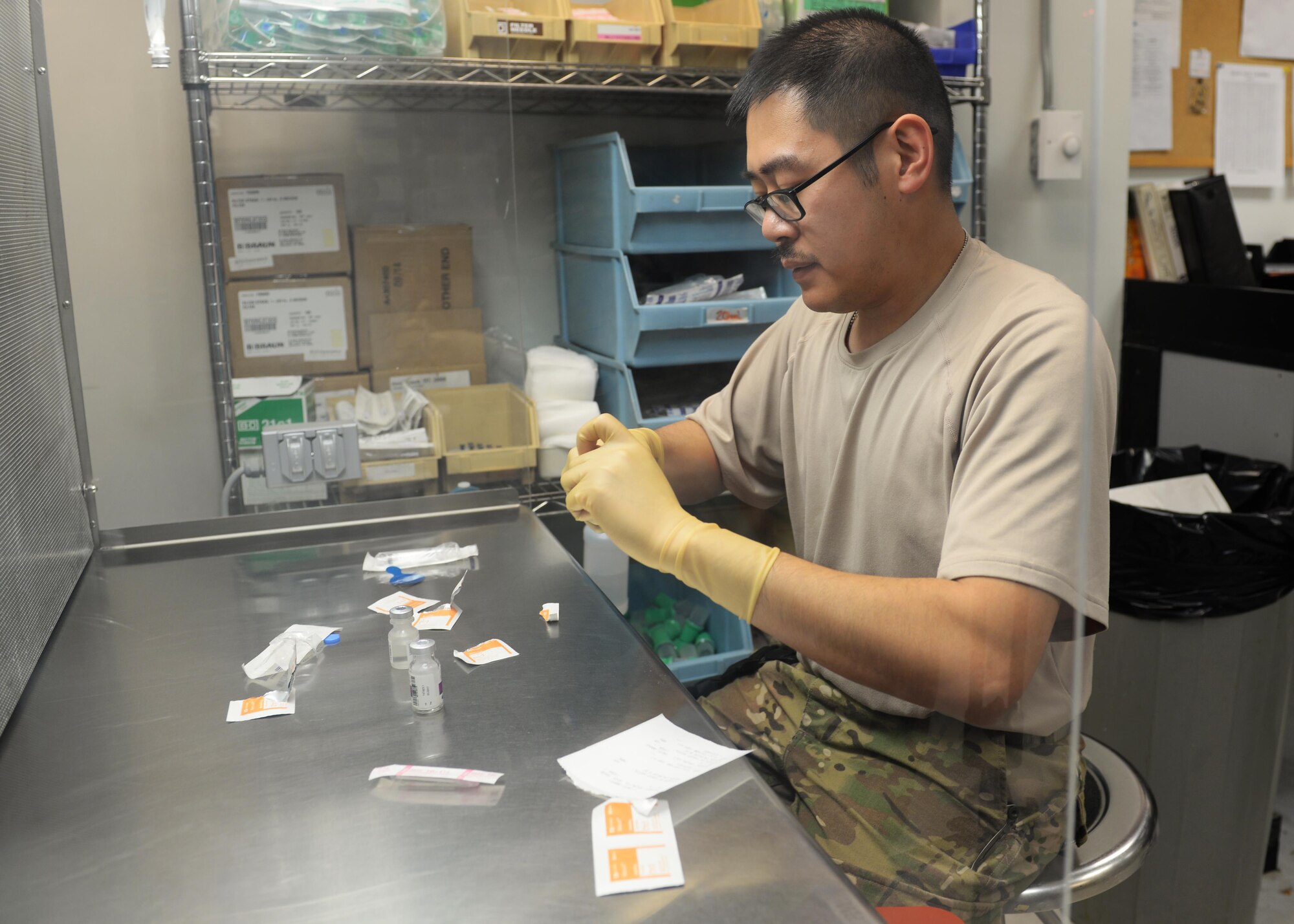 U.S. Air Force Capt. David Vuong, 455th Expeditionary Medical Operations Squadron pharmacist, prepares medication for a patient July 31, 2015, at the Craig Joint Theater Hospital, Bagram Airfield, Afghanistan. Vuong is responsible for keeping the pharmacy fully stocked with medications to treat patients at Bagram keeping them fit to fight and support the mission. (U.S. Air Force photo by Senior Airman Cierra Presentado/Released)