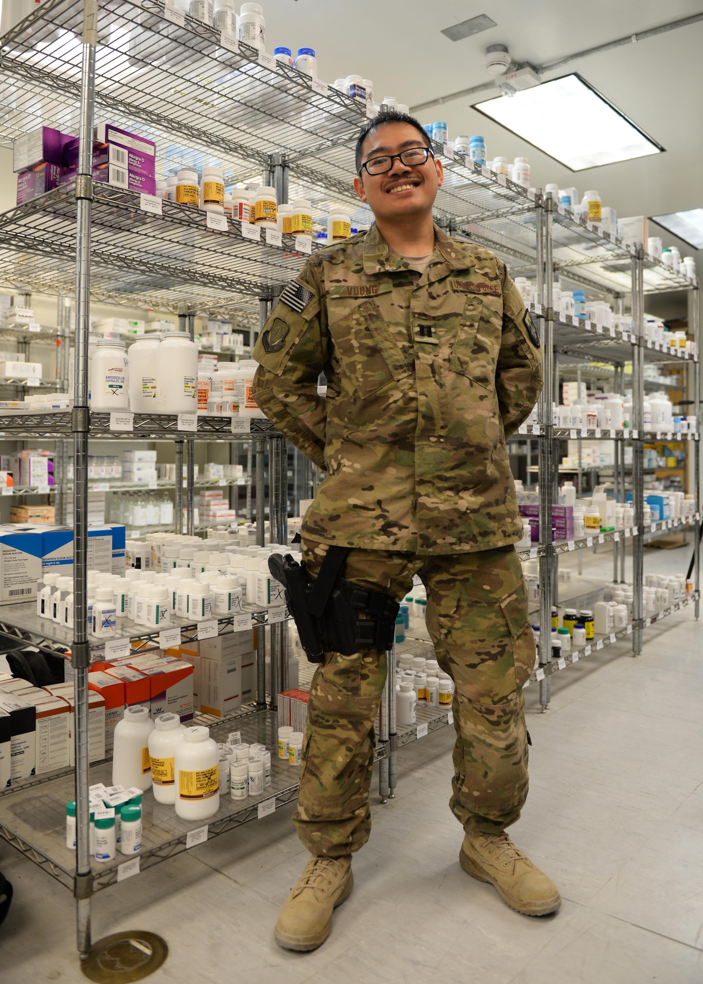 U.S. Air Force Capt. David Vuong, 455th Expeditionary Medical Operations Squadron pharmacist, poses for a photo July 31, 2015, at Bagram Airfield, Afghanistan. Vuong is responsible for keeping the pharmacy fully stocked with medications to treat patients of Bagram keeping them fit to fight and support the mission. (U.S. Air Force photo by Senior Airman Cierra Presentado/Released)